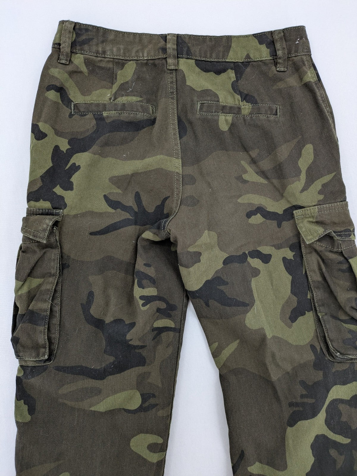 Rainbow camouflage cargo pants in green-brown with jogger silhouette and multiple pockets.