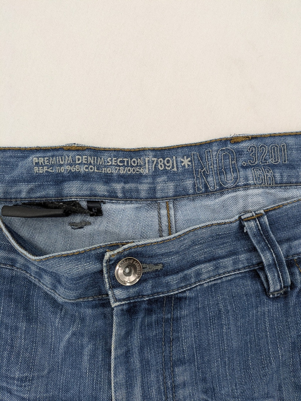 Premium Denim blue straight leg jeans with biker knee inserts and five-pocket design.