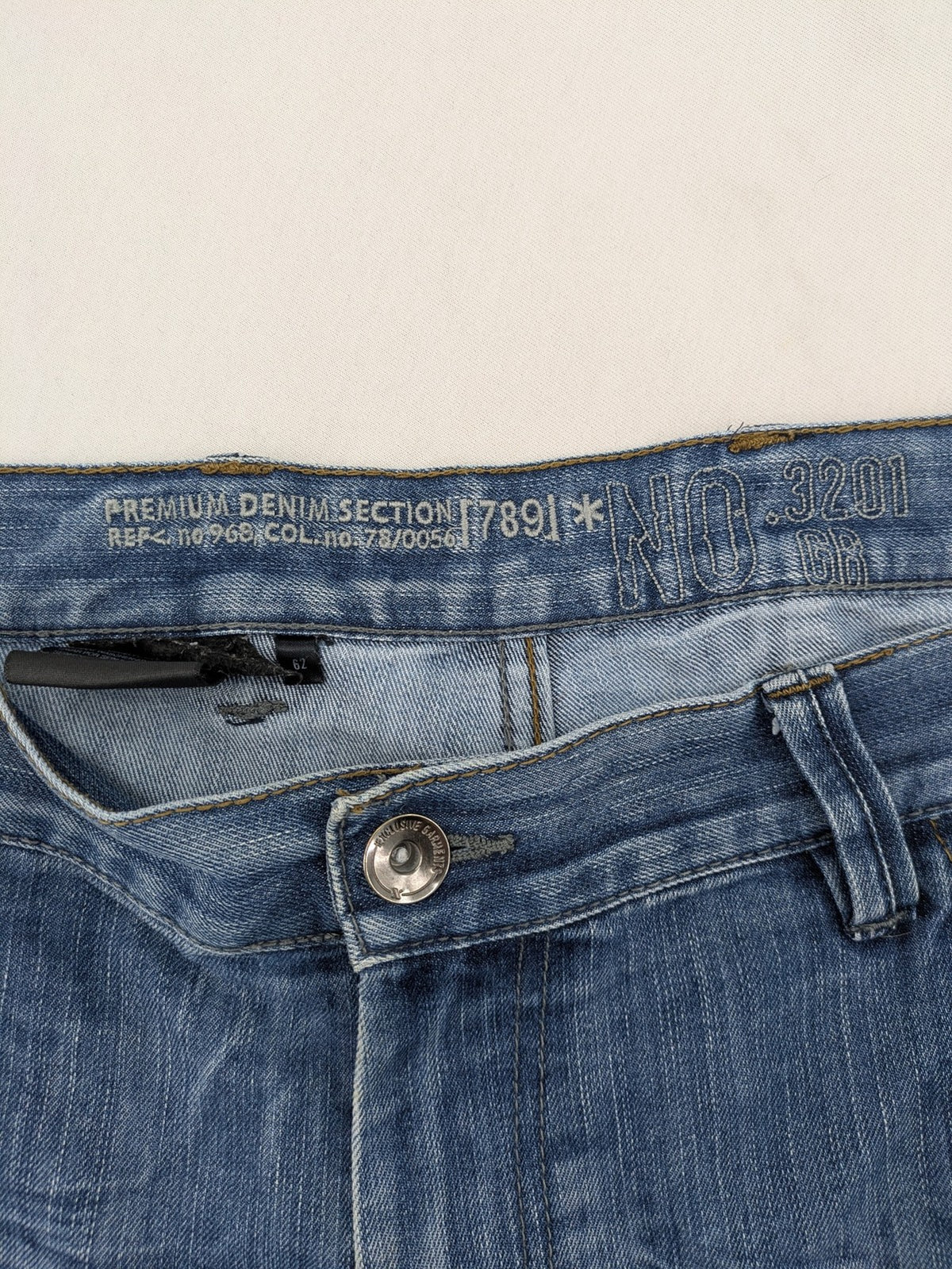 Premium Denim blue straight leg jeans with biker knee inserts and five-pocket design.