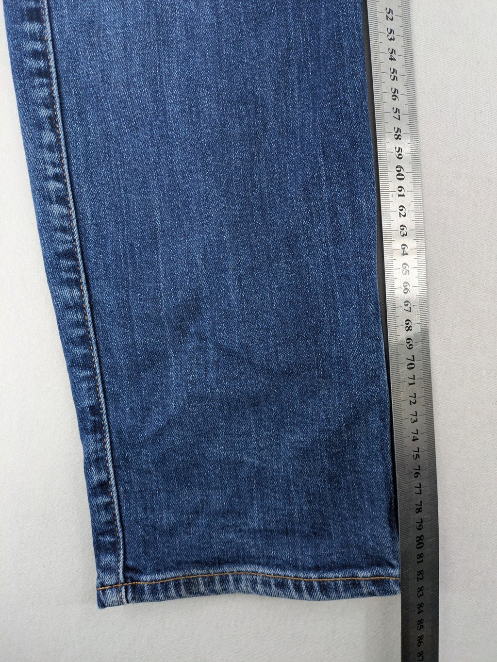 Mustang blue tapered jeans with slim fit, medium rise, and classic denim texture.