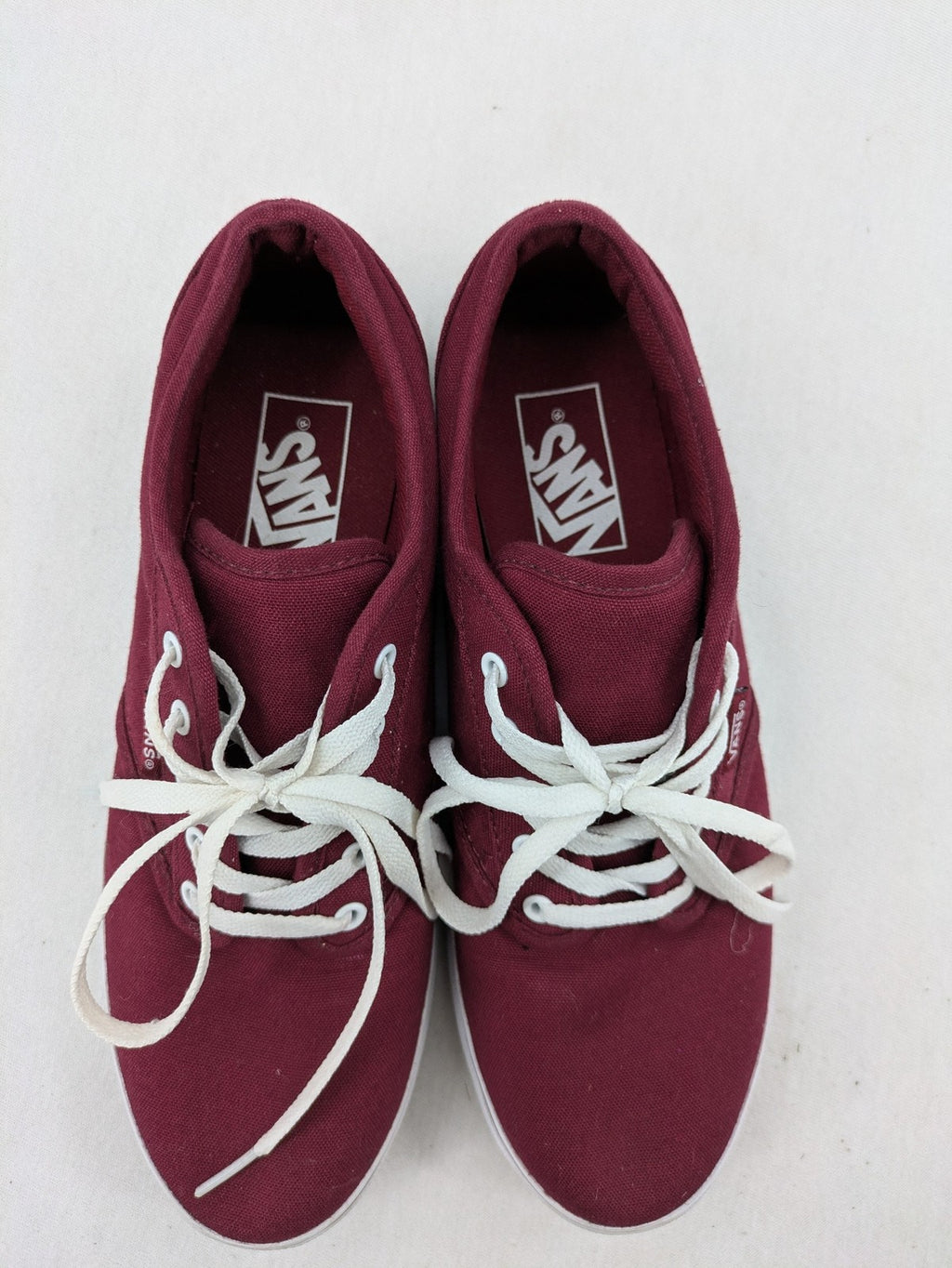 Vans low-top sneakers burgundy canvas with white logo and classic waffle sole.