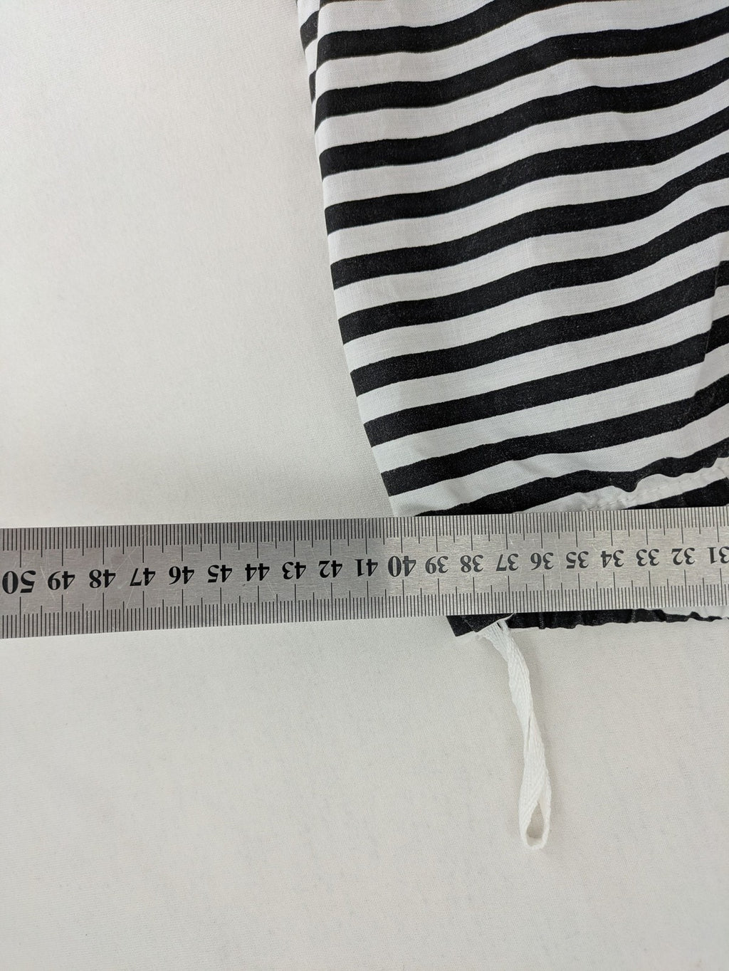 Rubie's costume set black and white striped with prisoner number patch on chest.