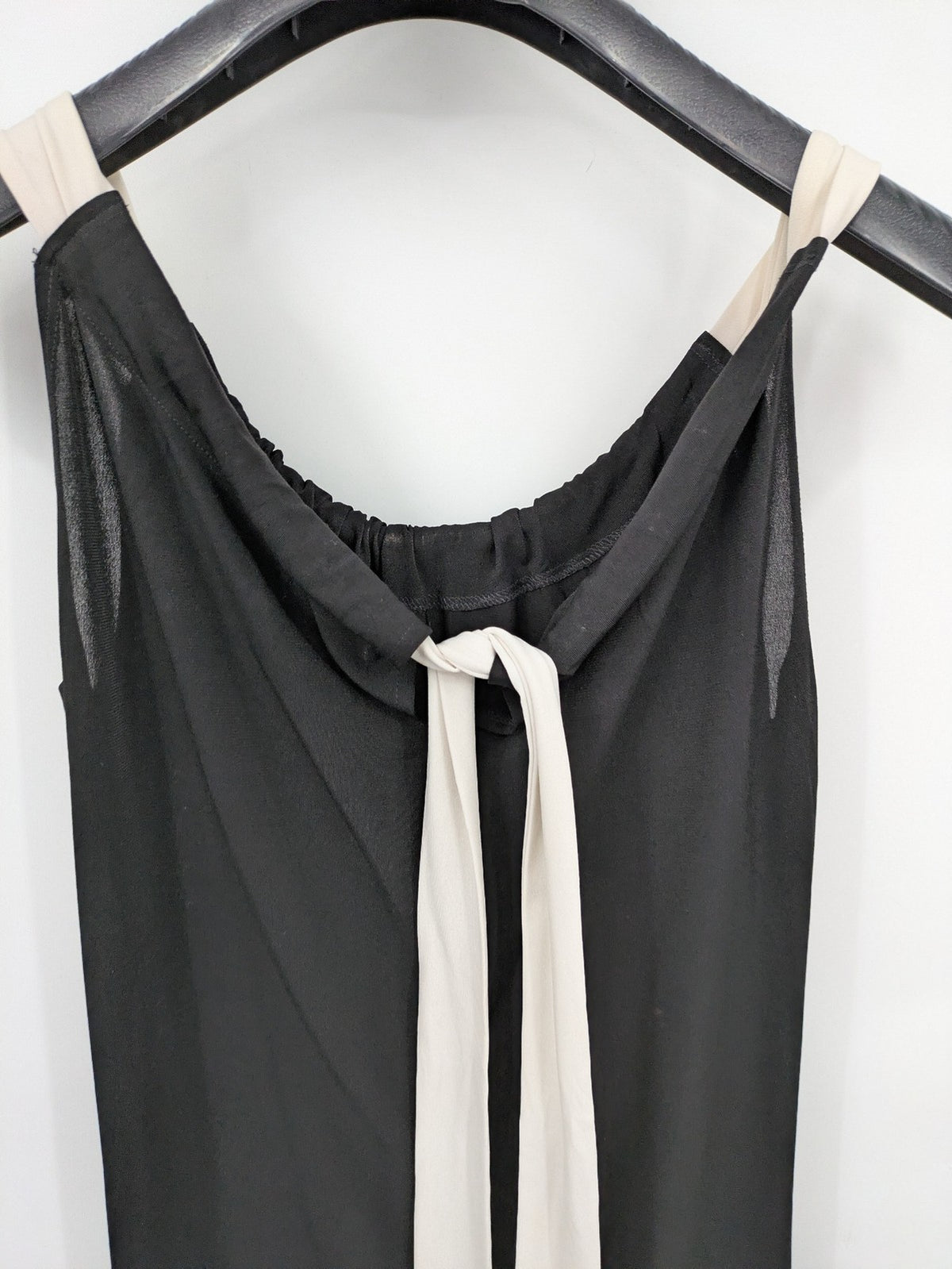 En Focus Studio beige and black top, sleeveless with beaded neckline and tie detail.
