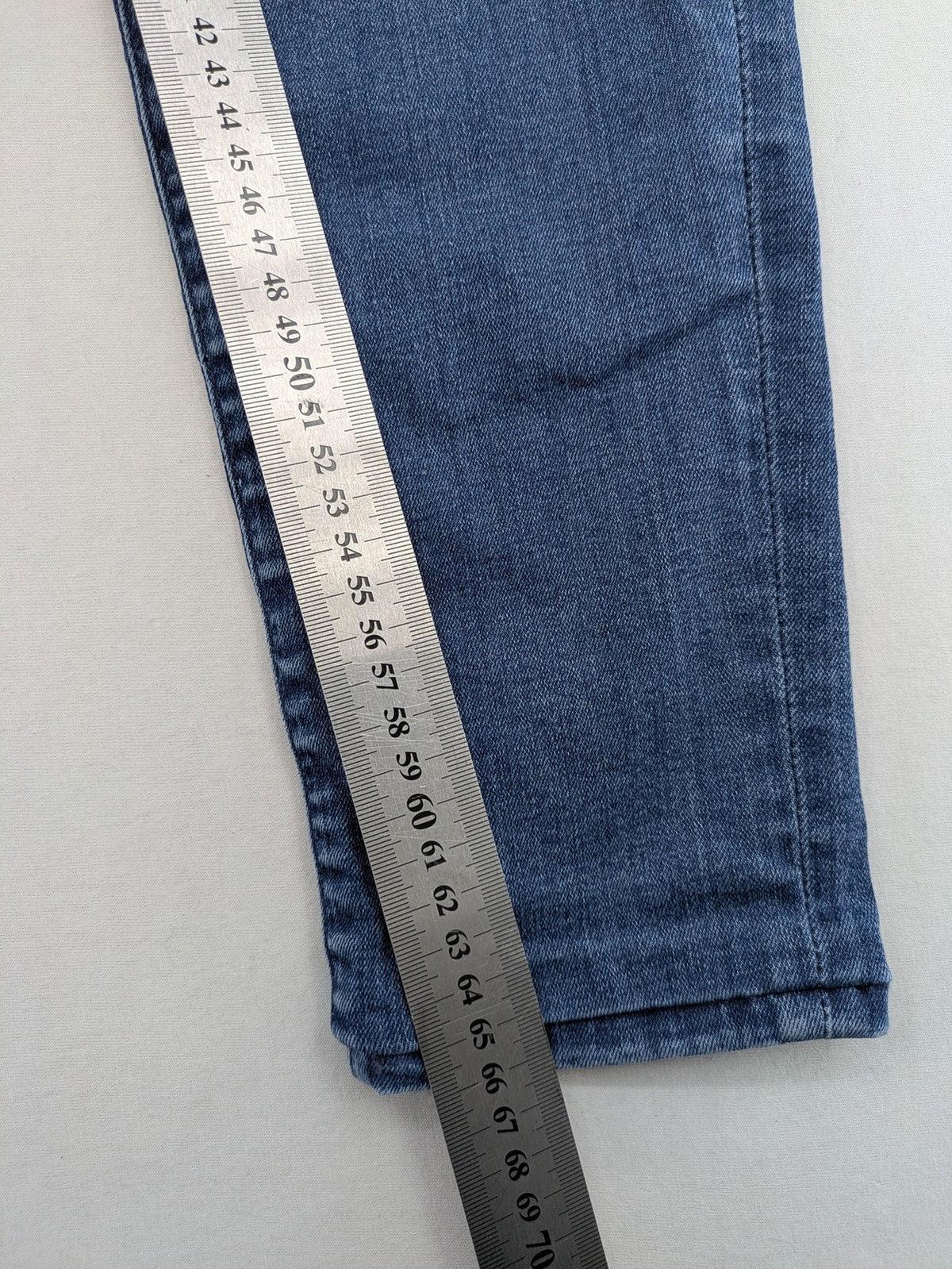 Mavi blue high rise super skinny jeans with medium wash and stretch denim material.