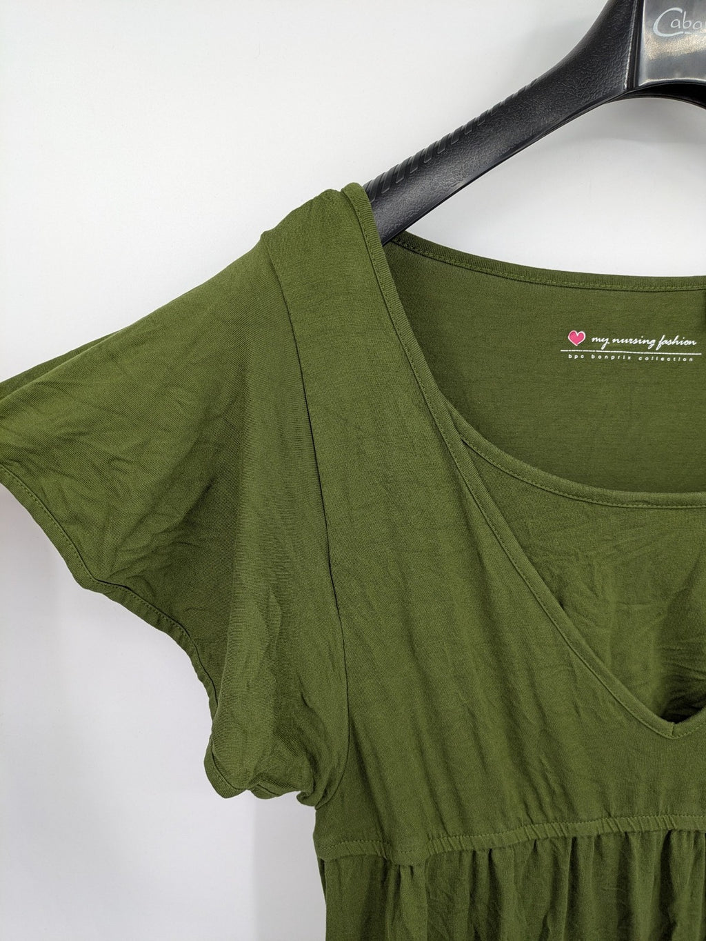 Bonprix green maternity dress with layered V-neck and empire waist design.