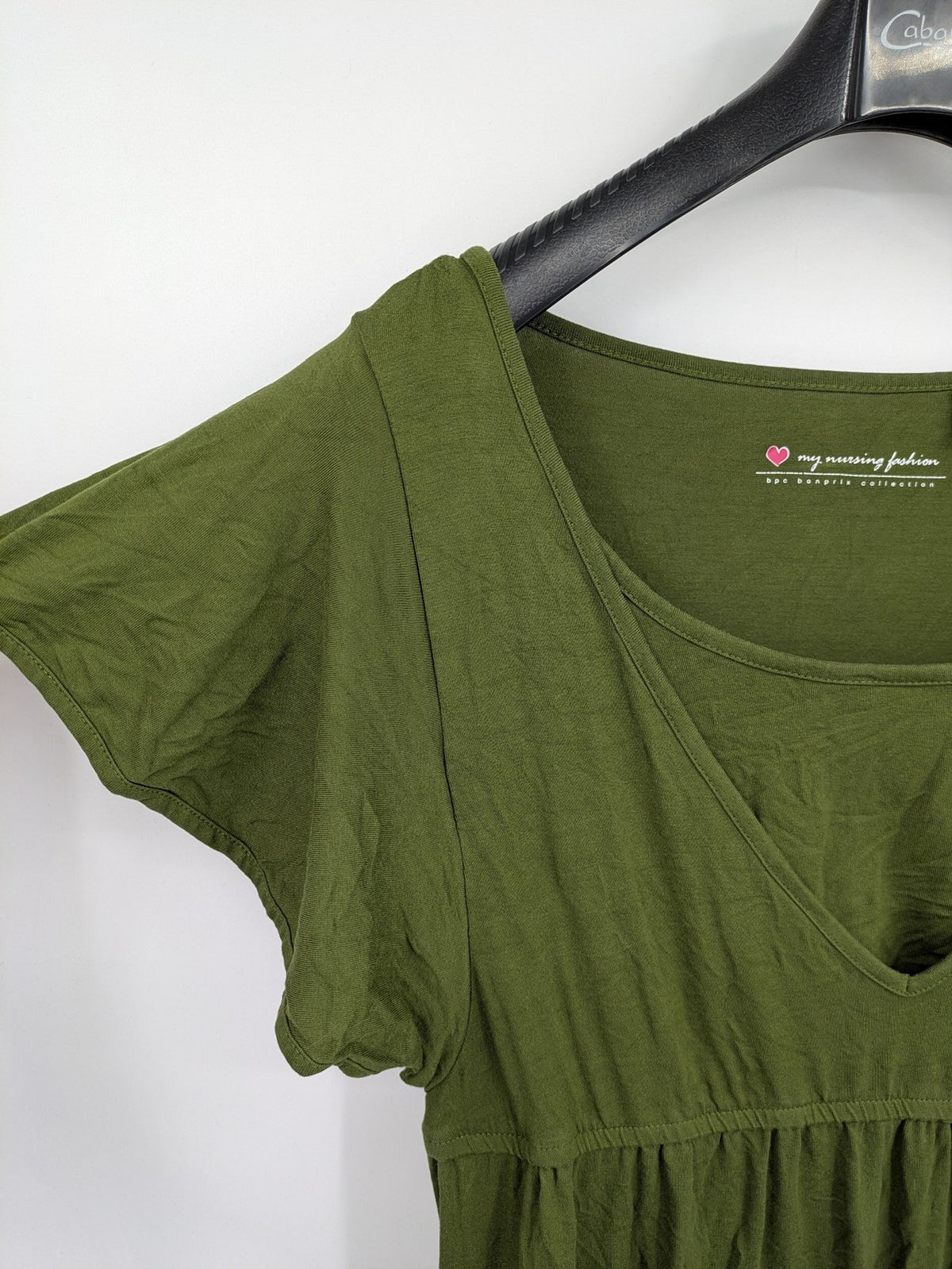 Bonprix green maternity dress with layered V-neck and empire waist design.