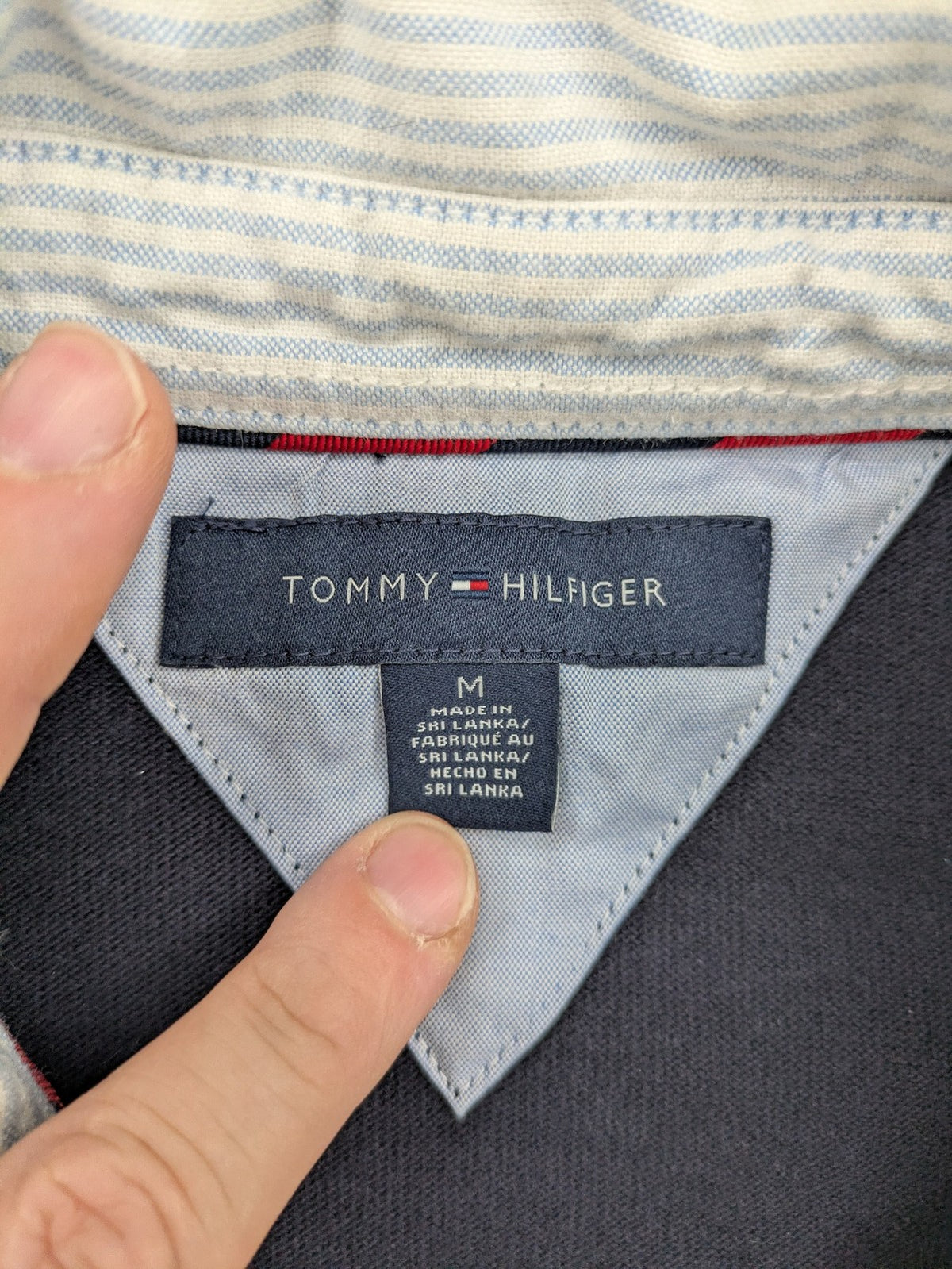 Tommy Hilfiger grey rugby polo shirt with navy striped collar and large H logo.