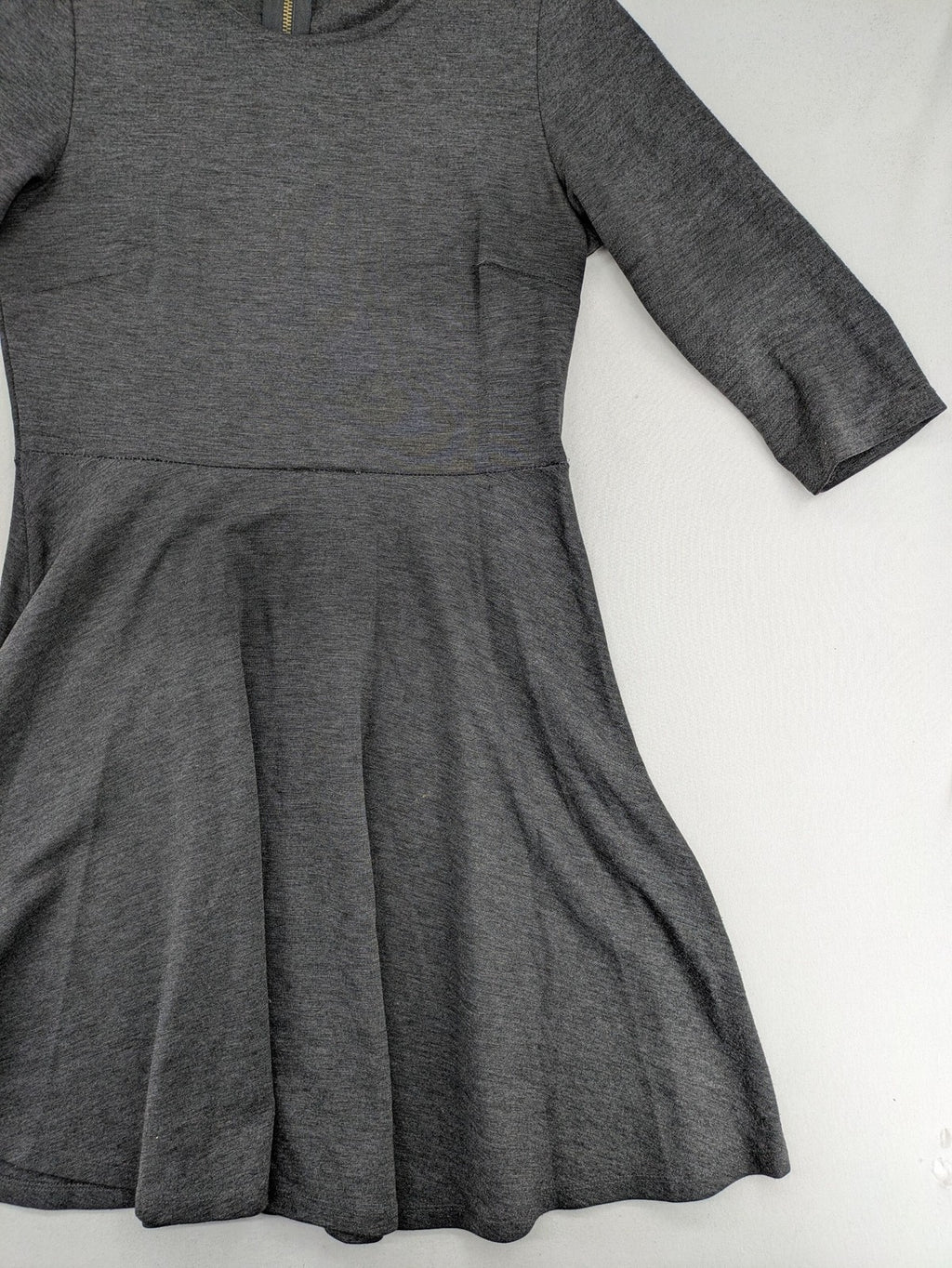 Ginatricot grey A-line skater dress with 3/4 sleeves and visible back zipper.
