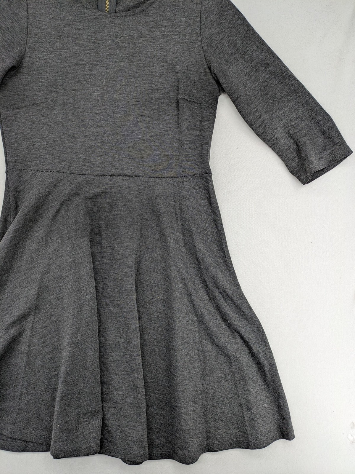 Ginatricot grey A-line skater dress with 3/4 sleeves and visible back zipper.