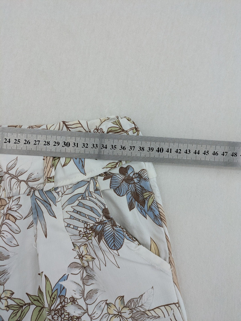Made in Italy multi pants tropical floral pattern cotton-viscose blend on white background.