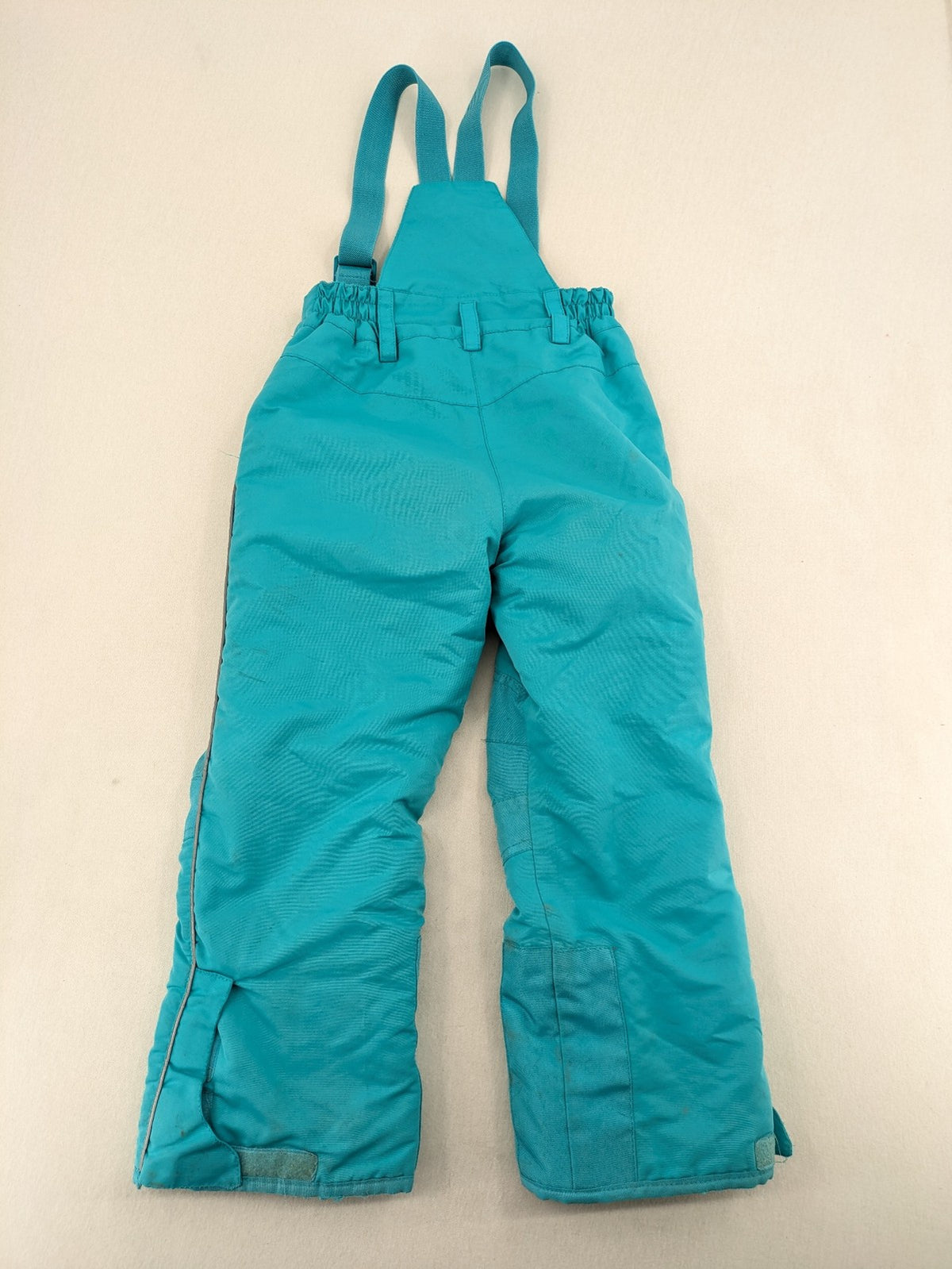 Topolino blue and turquoise snow pants with adjustable straps and fleece-lined bib.