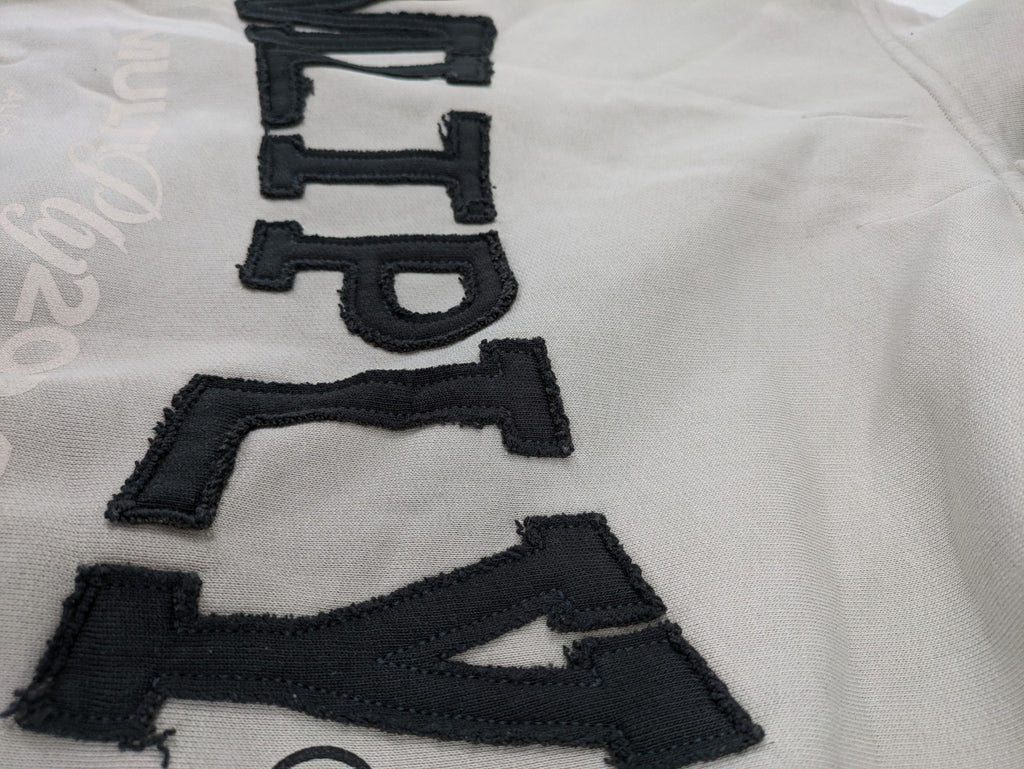 Multiply grey zip-through hoodie with embroidered logo and large "MLTPLY" print on back.