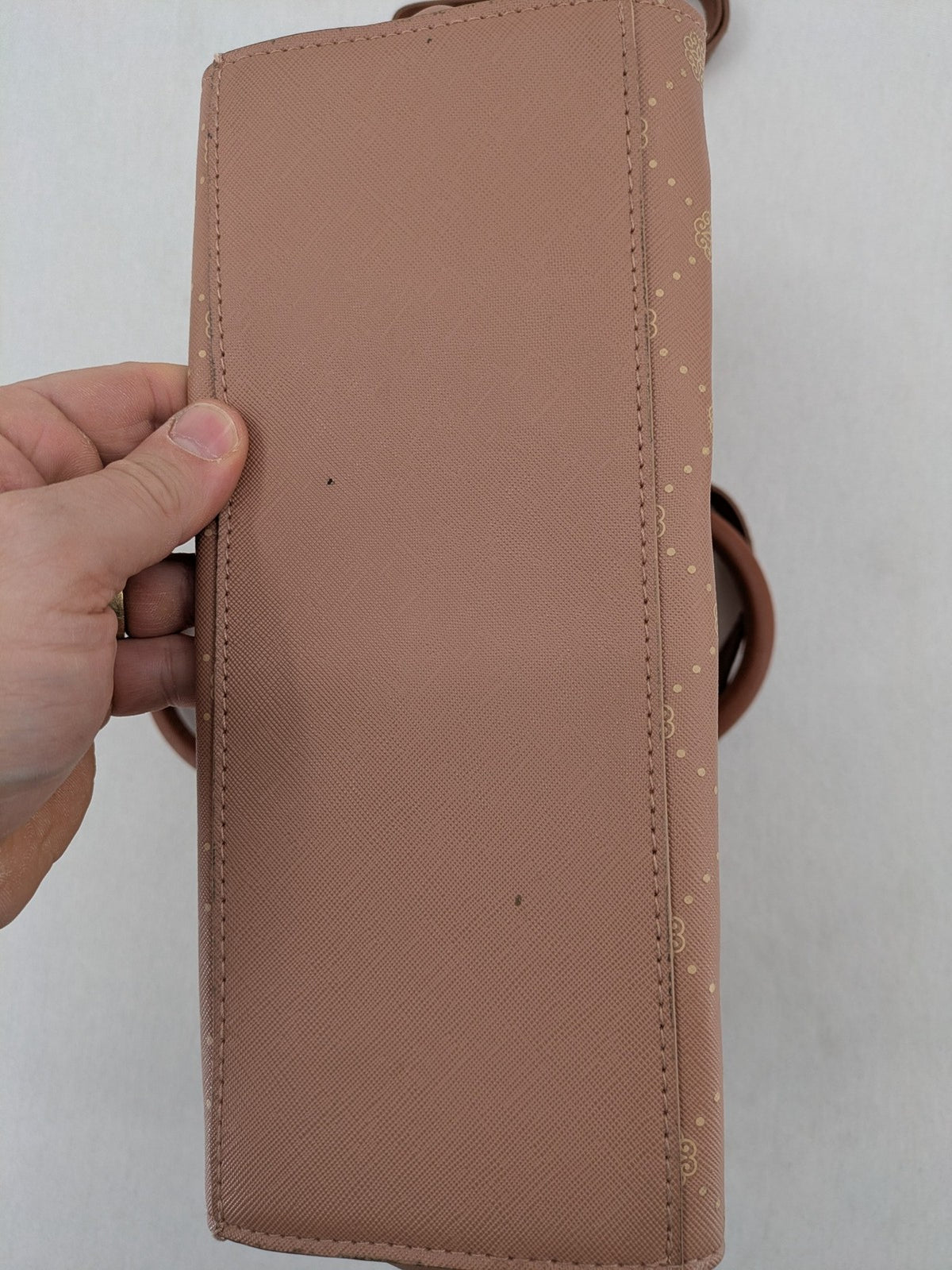 Catwalk gold handbag with pink and brown monogram pattern, adjustable shoulder strap.