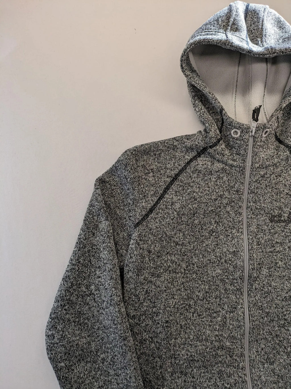 Jack Wolfskin grey fleece jacket with logo detailing and two front pockets.