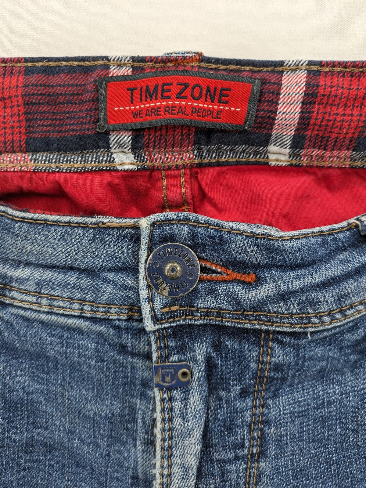 Timezone blue straight jeans slim fit with checkered pattern lining and button fly.