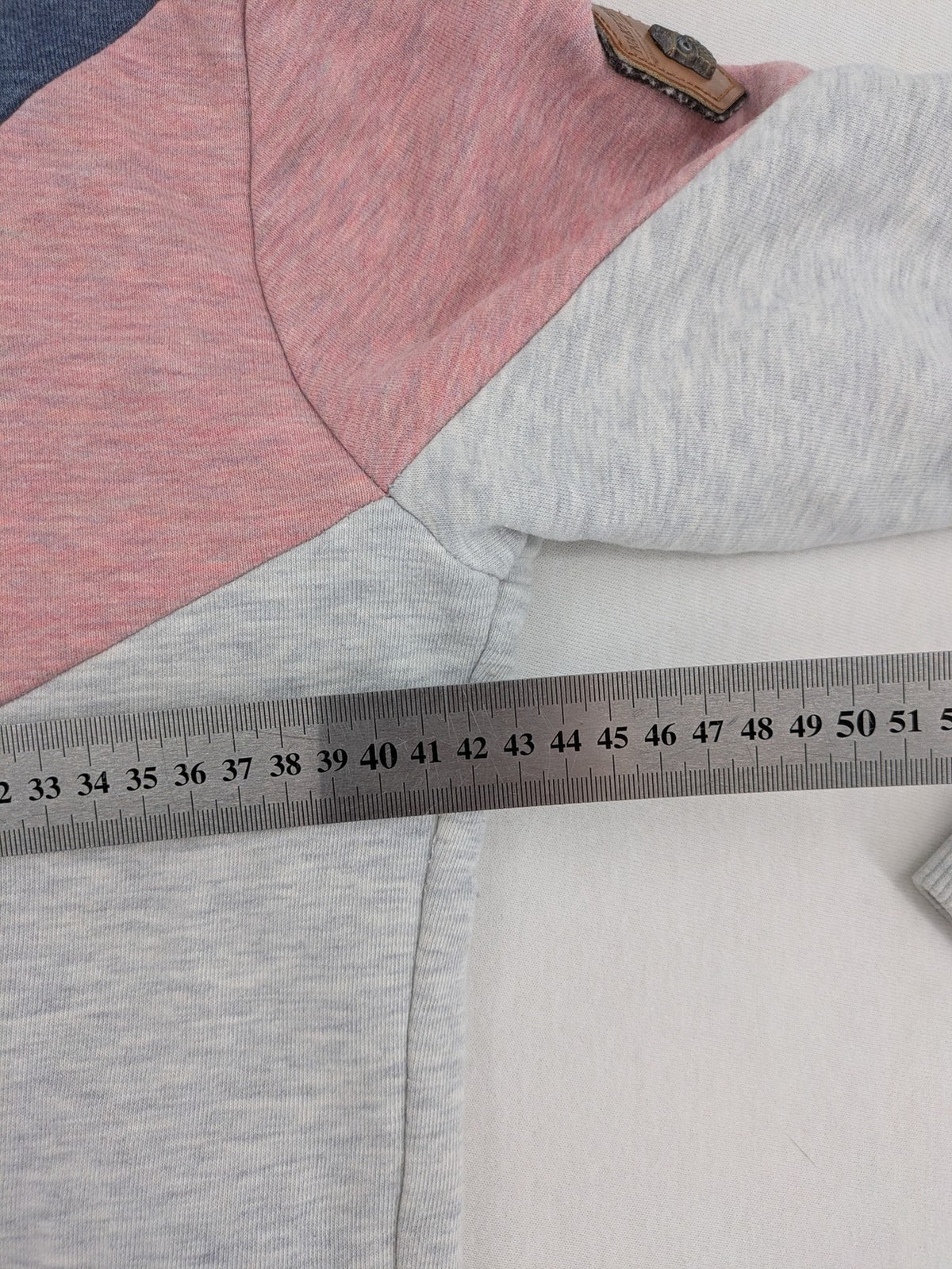 Naketano multi turtle neck jumper colorblock design in blue, pink, and grey.