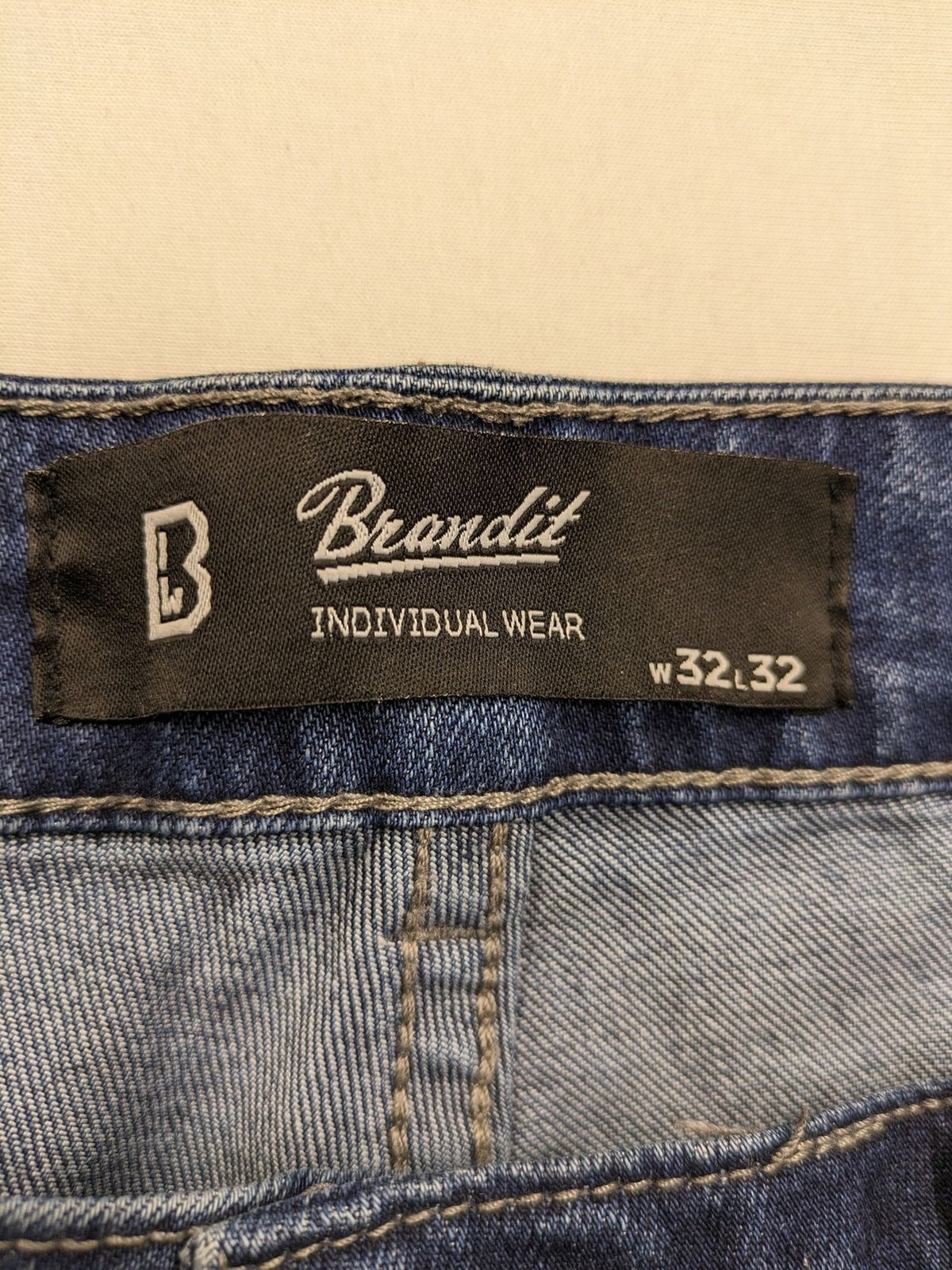 Brandit blue straight jeans with distressed details, button fly, and classic 5-pocket style.