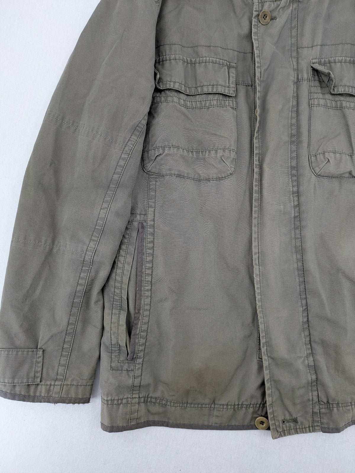 Walbusch khaki military jacket with checkered blue-white lining and multiple pockets.