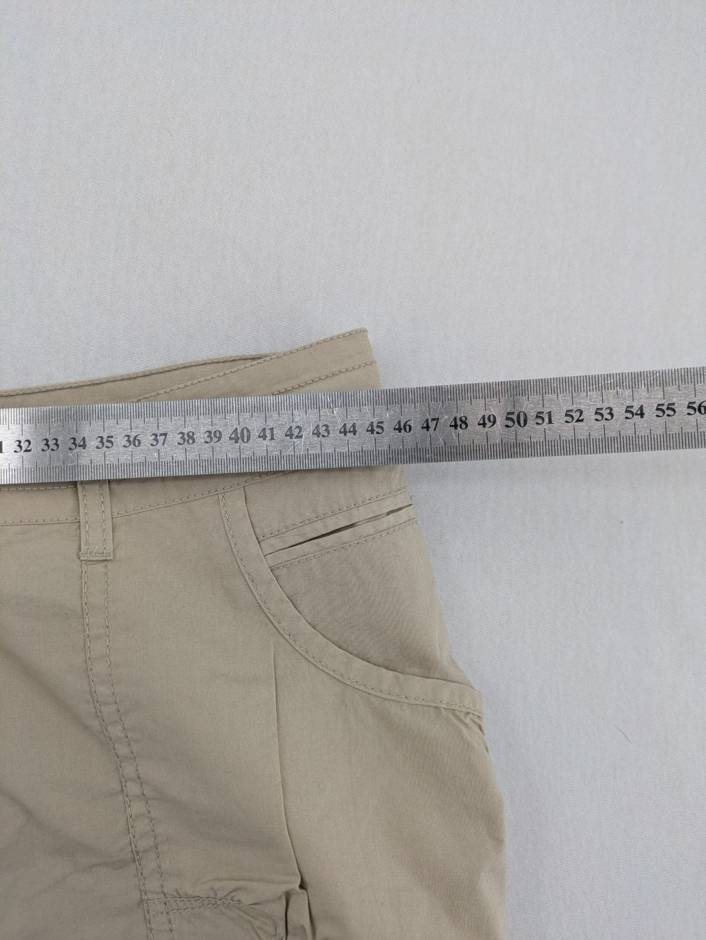 ESMARA beige cargo mini skirt with utility pockets and classic zipper button closure.