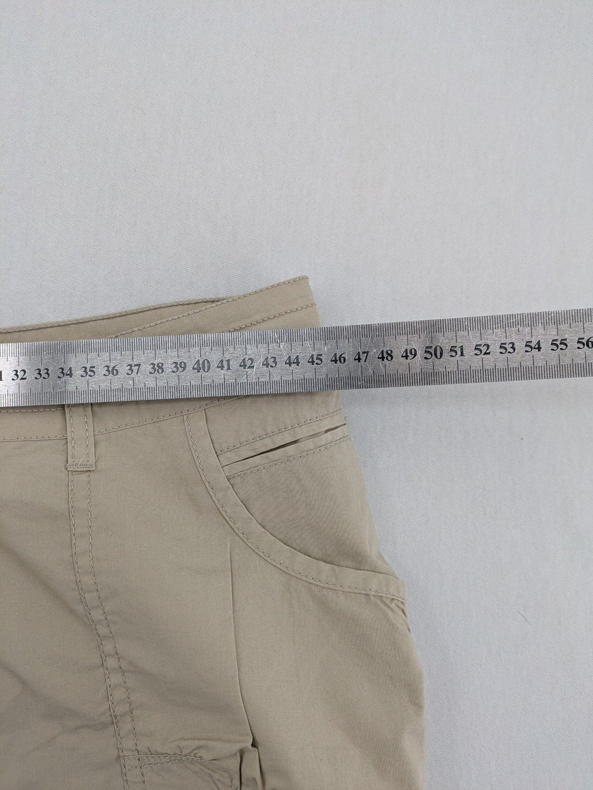 ESMARA beige cargo mini skirt with utility pockets and classic zipper button closure.