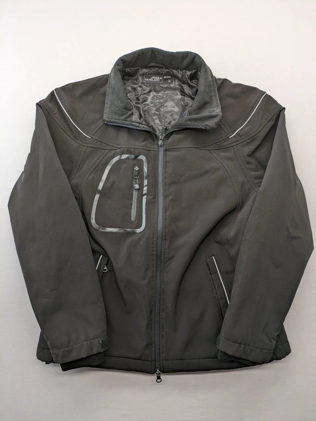 James & Nicholson grey softshell jacket with fleece lining and multiple zip pockets.
