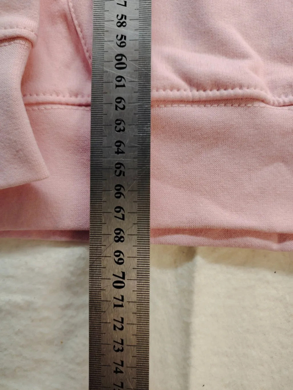 Just Hoods pink zip-through hoodie with "Trinkerbell" graphic, kangaroo pocket, drawstring hood.