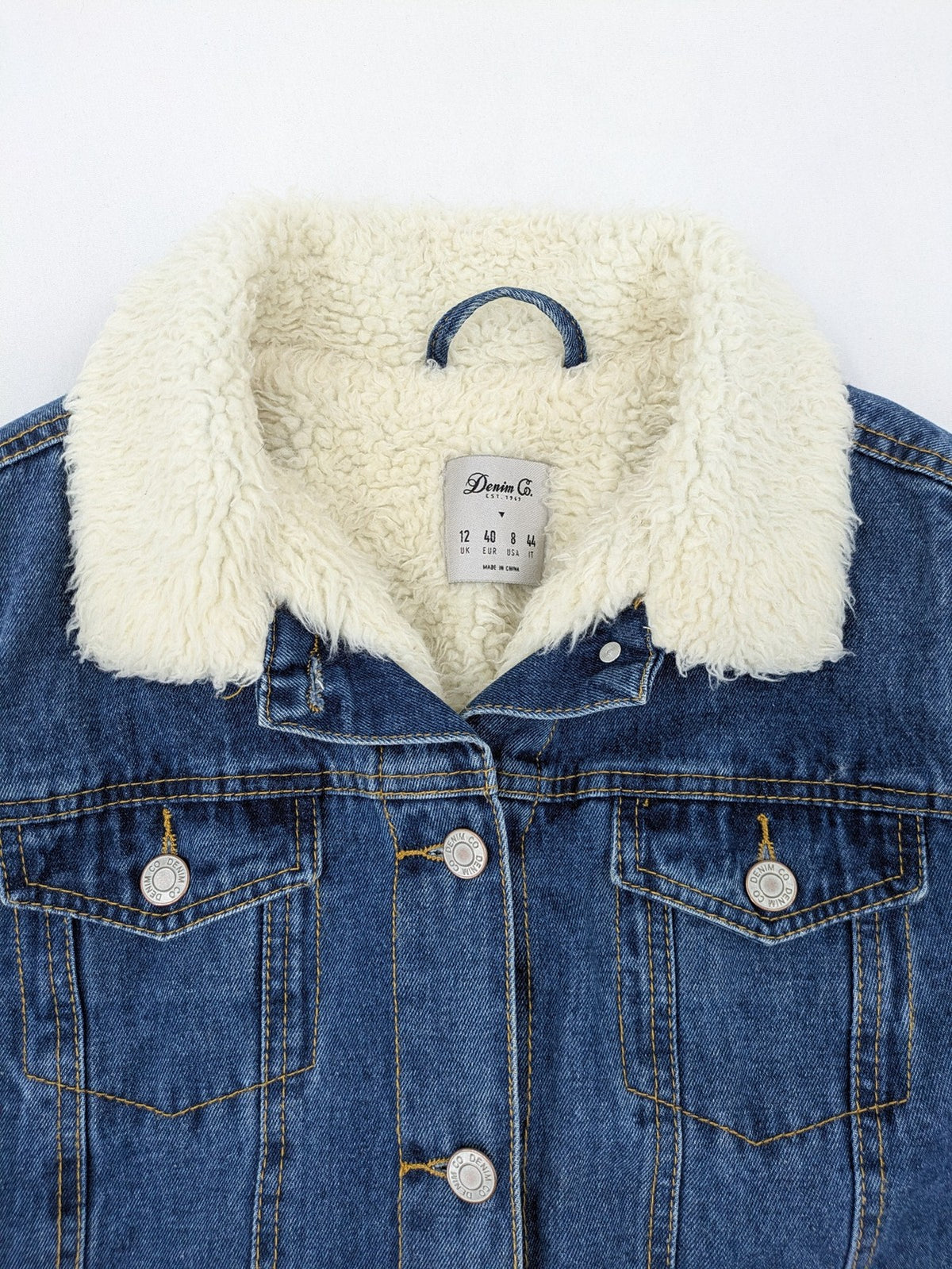 Denim & Co. blue jacket with cream Sherpa lining, button closure, and pockets.