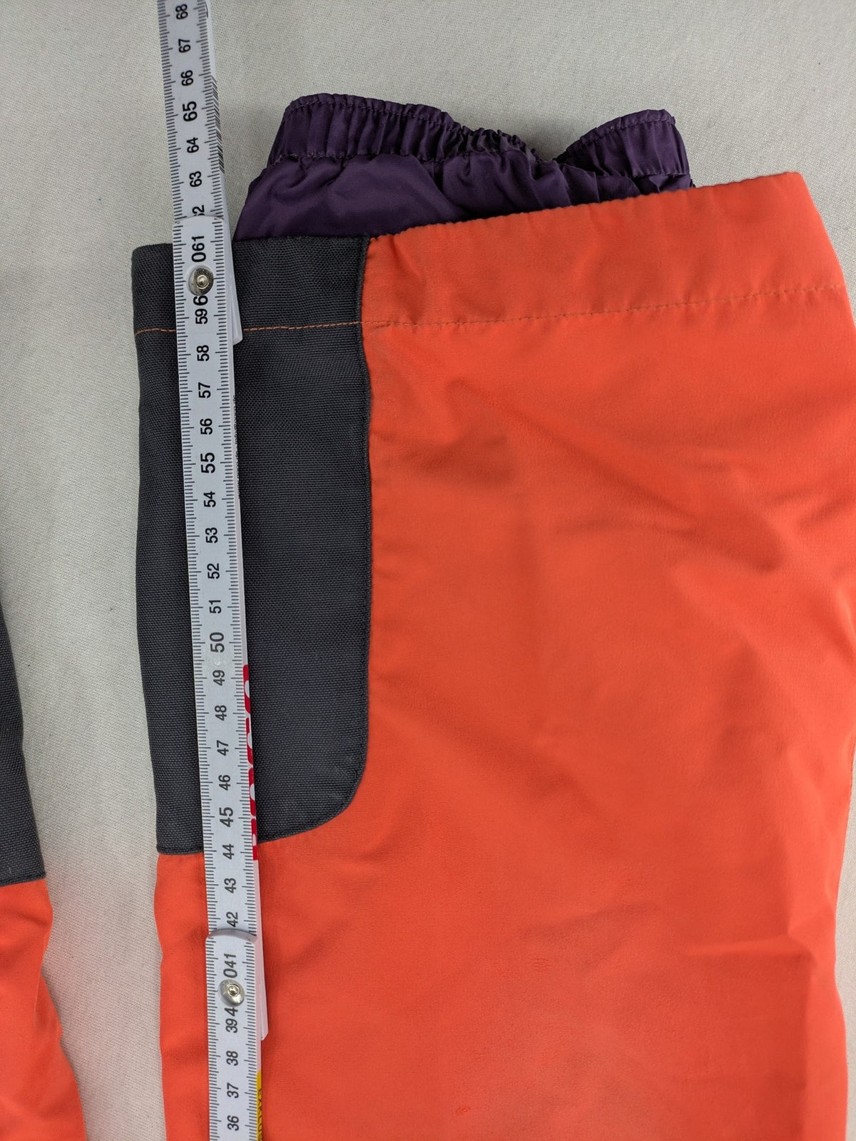 Vaude orange ski pants with logo, Primaloft insulation, and Ceplex Active membrane.