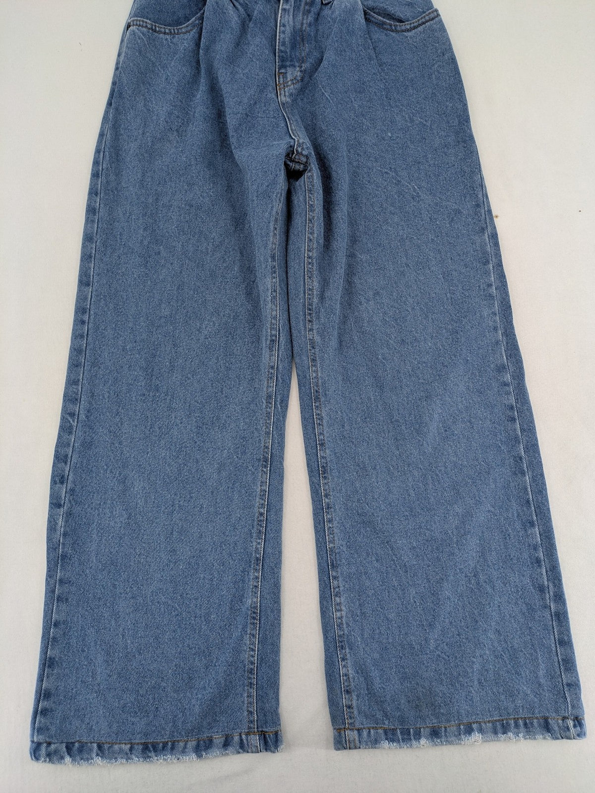 X.LOVE blue high waist wide leg jeans with front pleats and frayed hem.