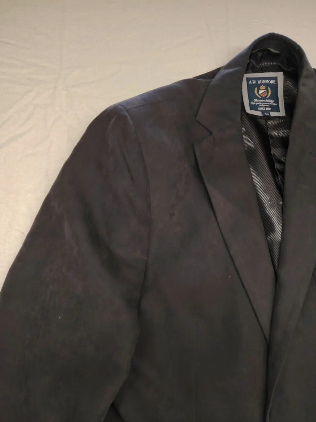 dunmore black blazer two-button design with falling lapels and multiple pockets