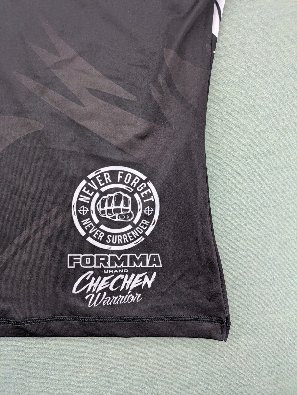 FORMMMA black rashguard featuring striking white wolf graphic and "Chechen Warrior" text.