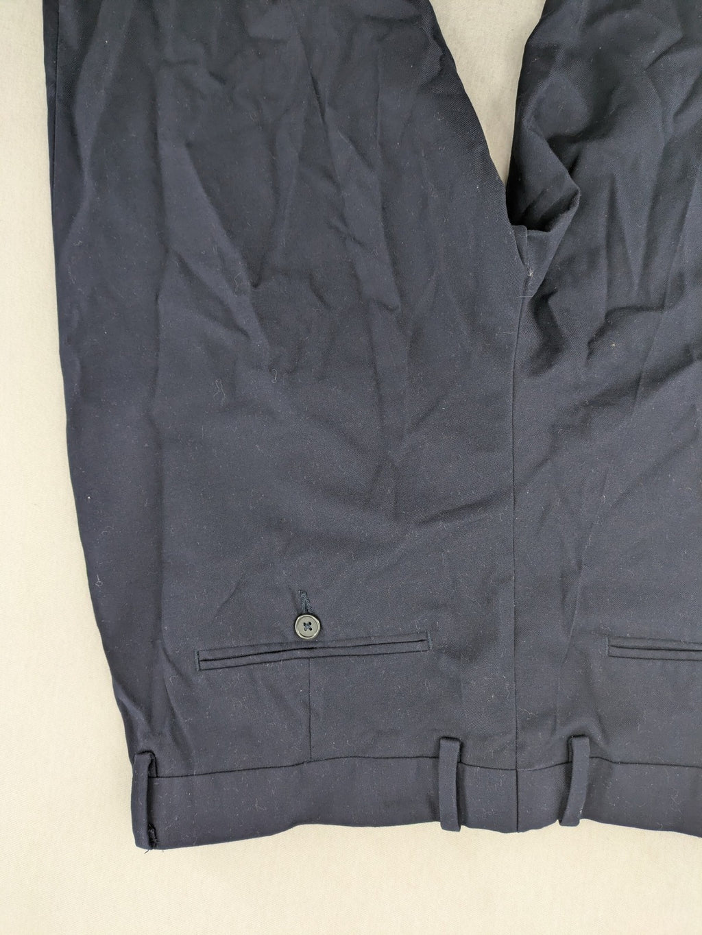H&M navy slim fit executive suit trousers with flat-front design and side pockets.