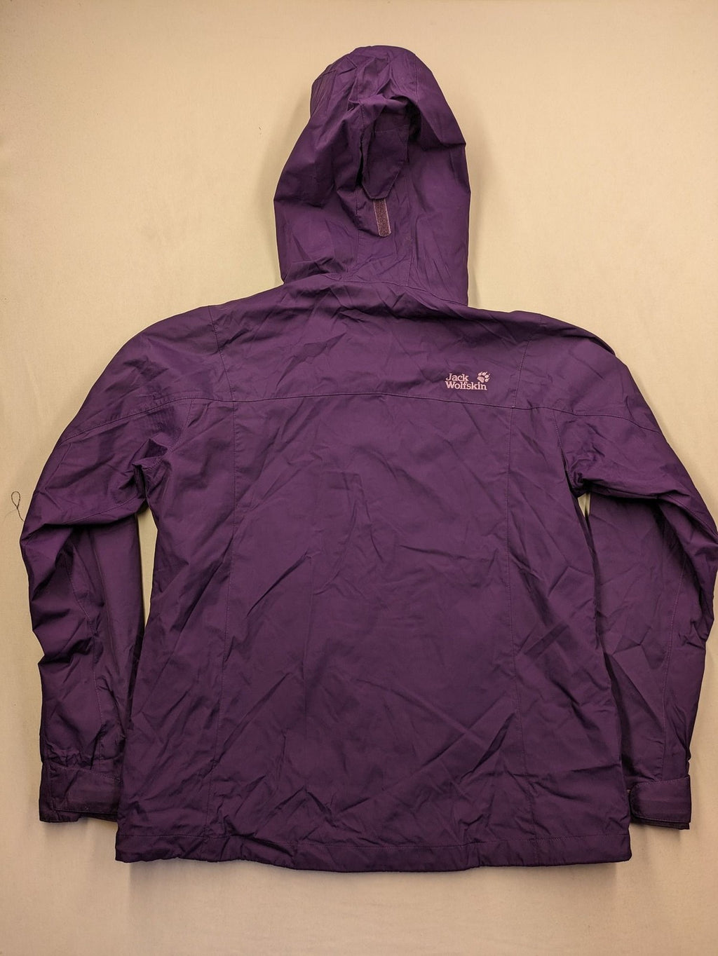 Jack Wolfskin purple outdoor jacket with adjustable hood and full zip, lightweight Stormlock material.