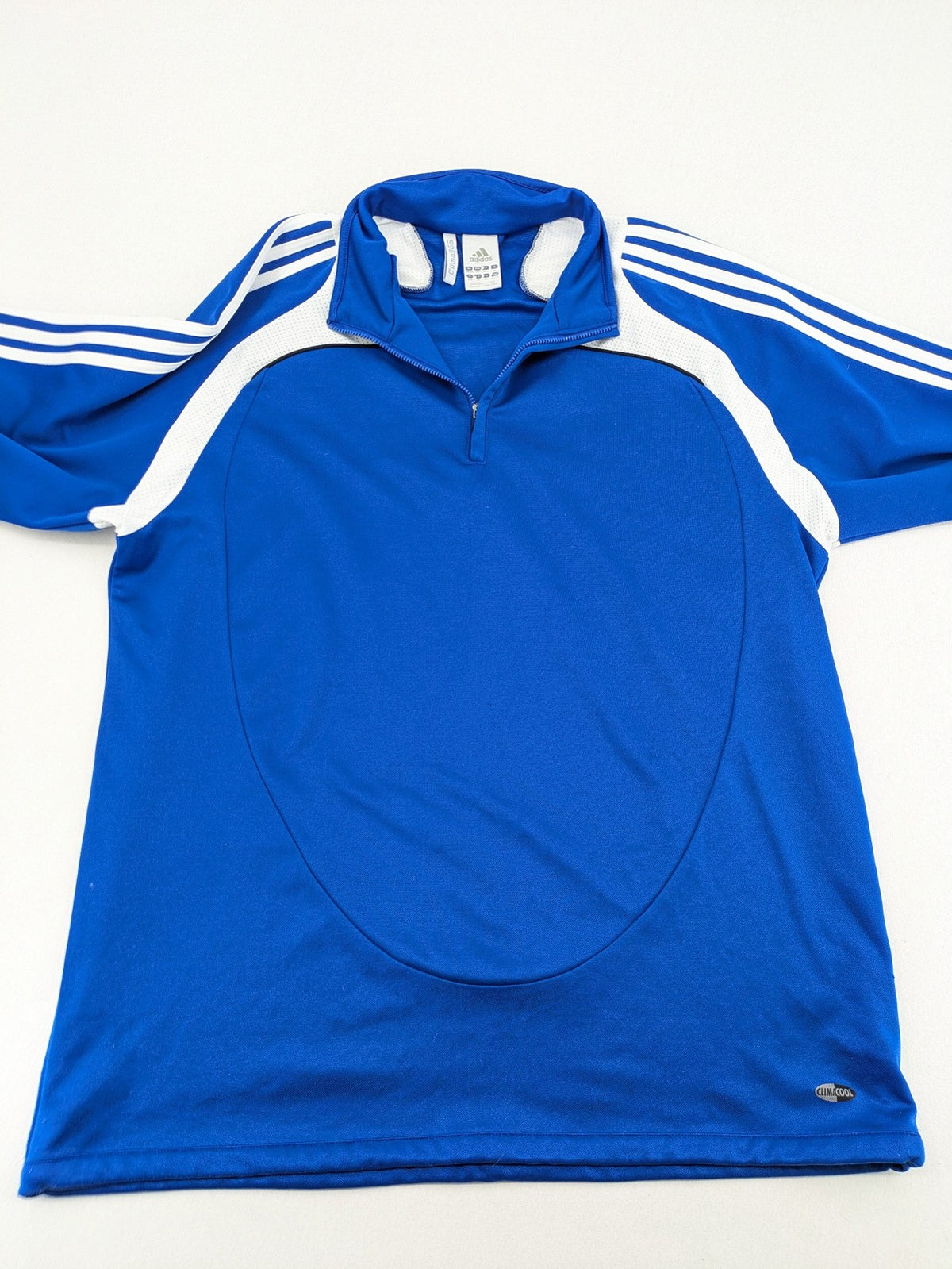 Adidas blue long sleeve top with white three stripes and 1/4 zip collar.
