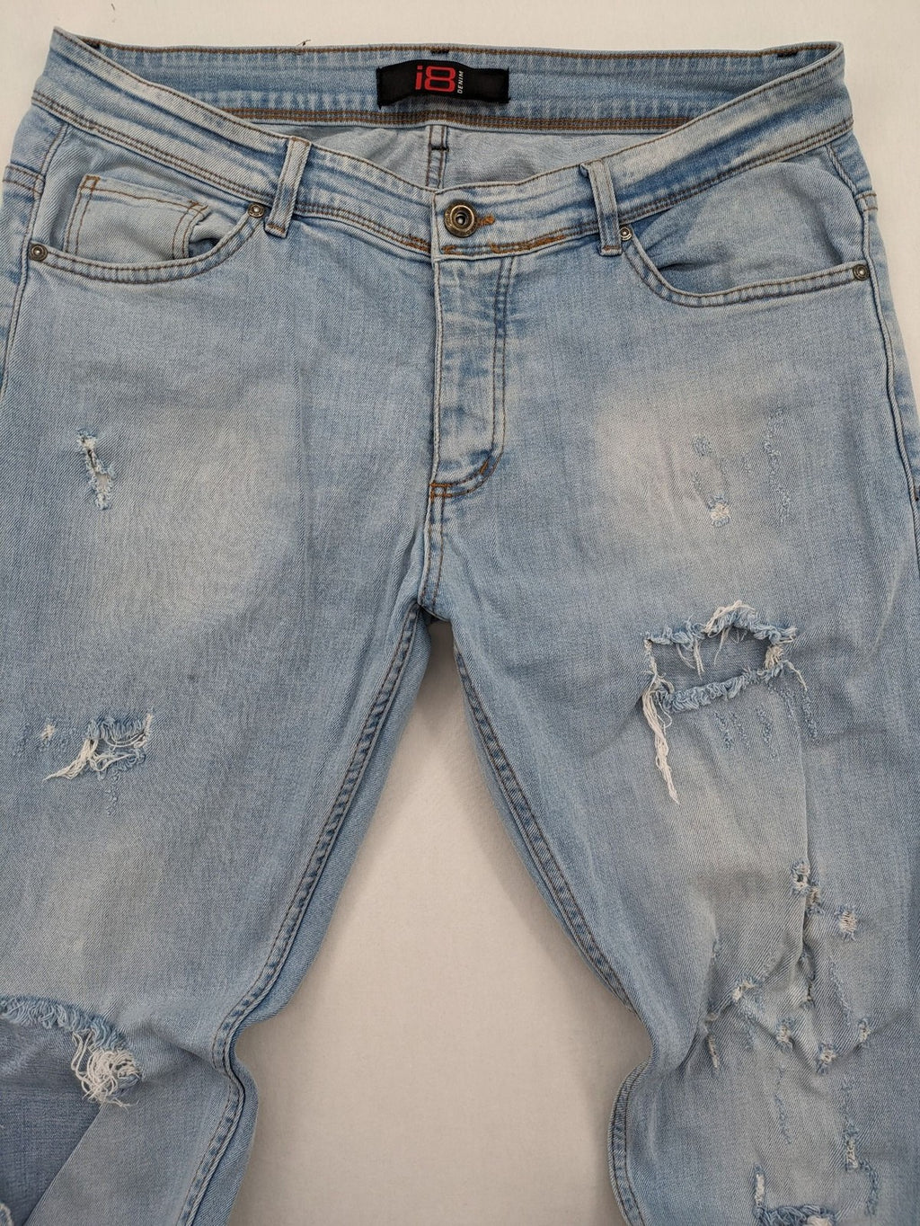 i8 Denim blue straight jeans destroyed look with frayed hems and classic button fly.