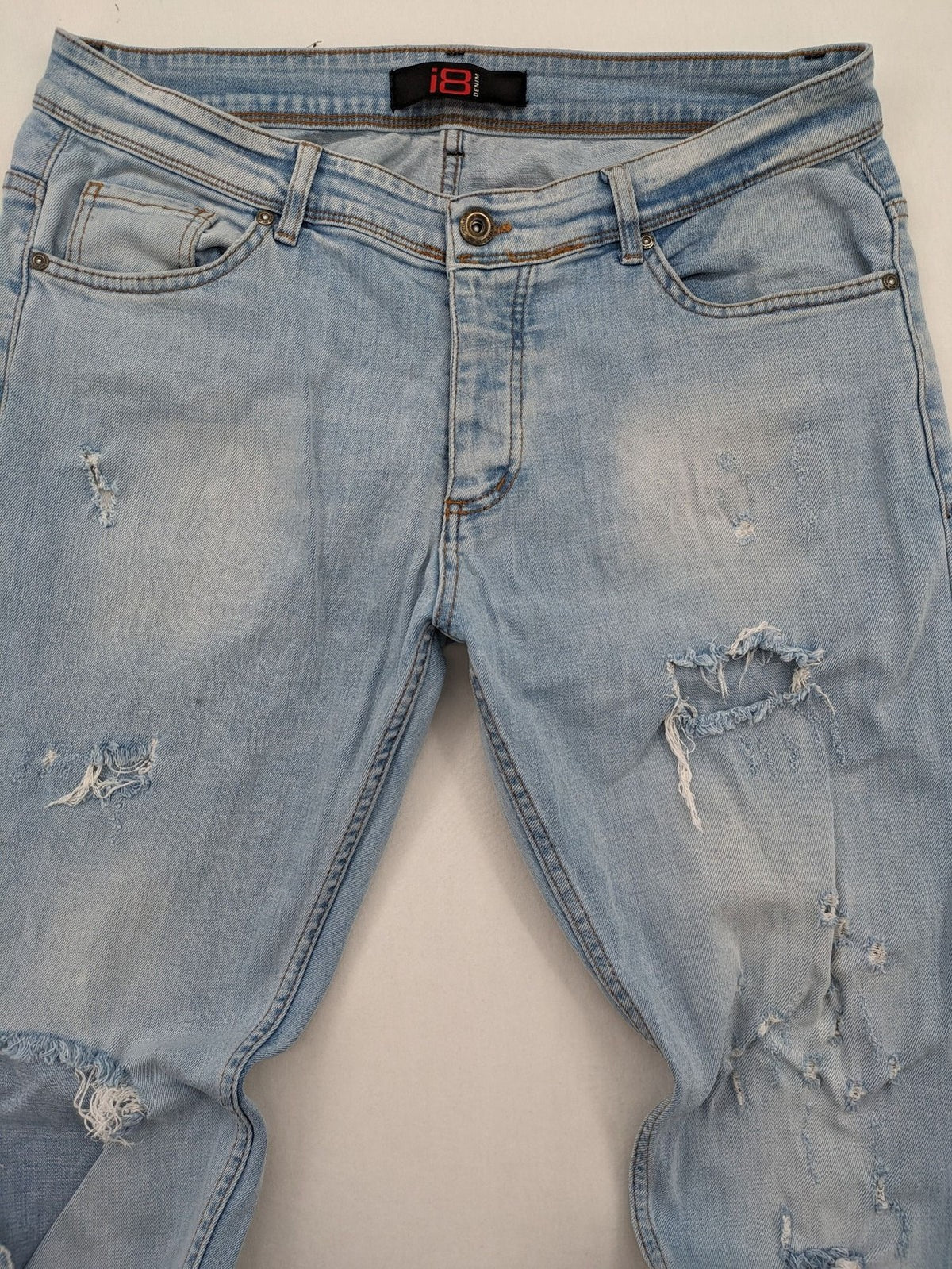 i8 Denim blue straight jeans destroyed look with frayed hems and classic button fly.