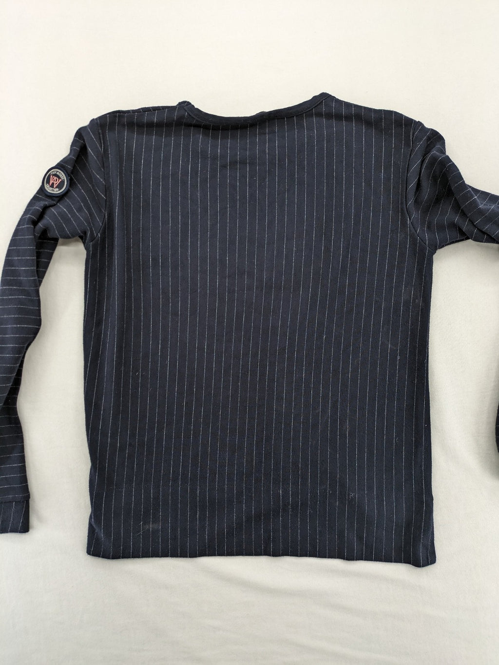 RIVER WOODS navy long sleeve top with white pinstripes and red "I AM très jolie" slogan.