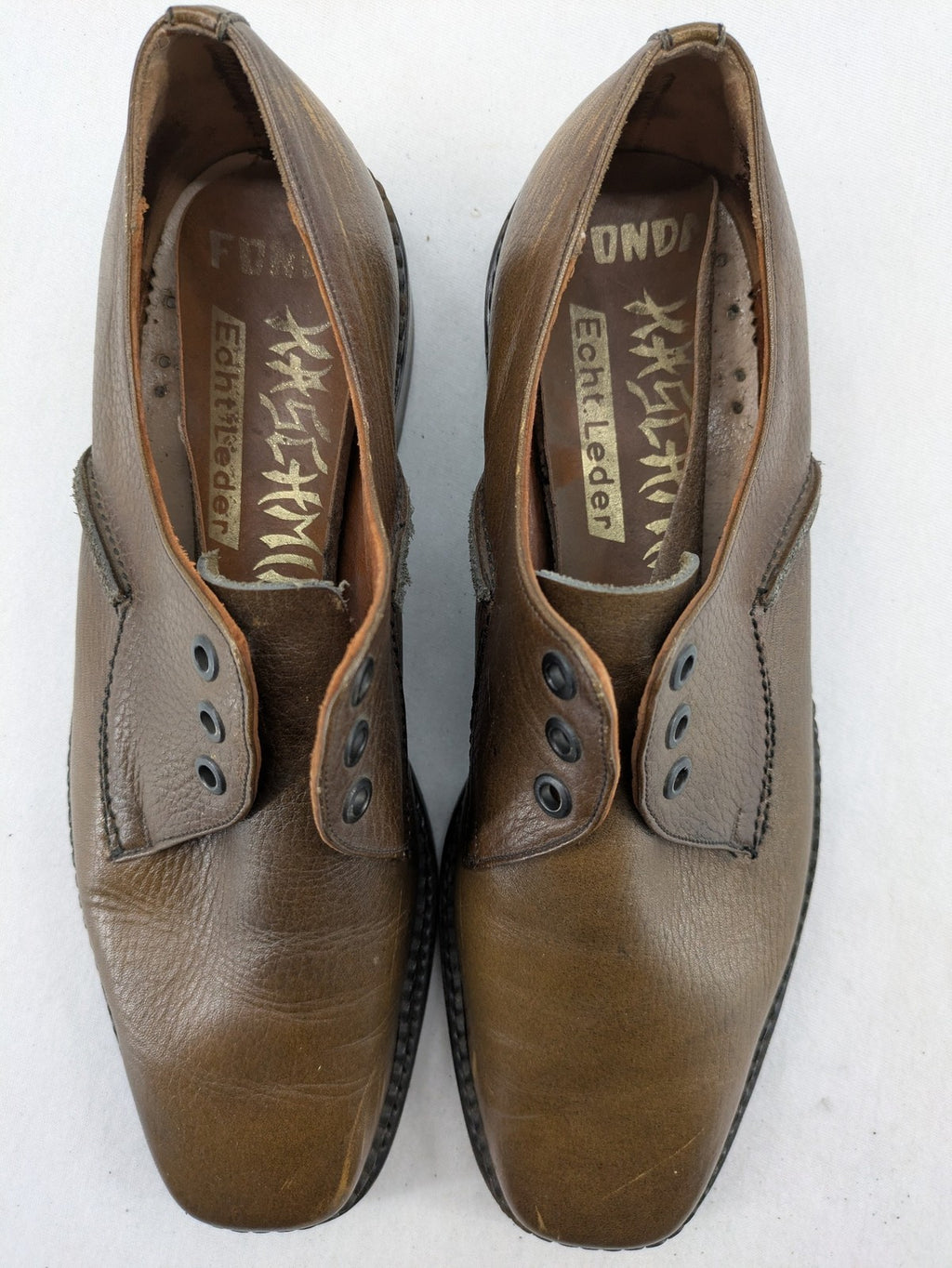 Fonda brown deck shoes genuine leather square toe design with decorative stitching.