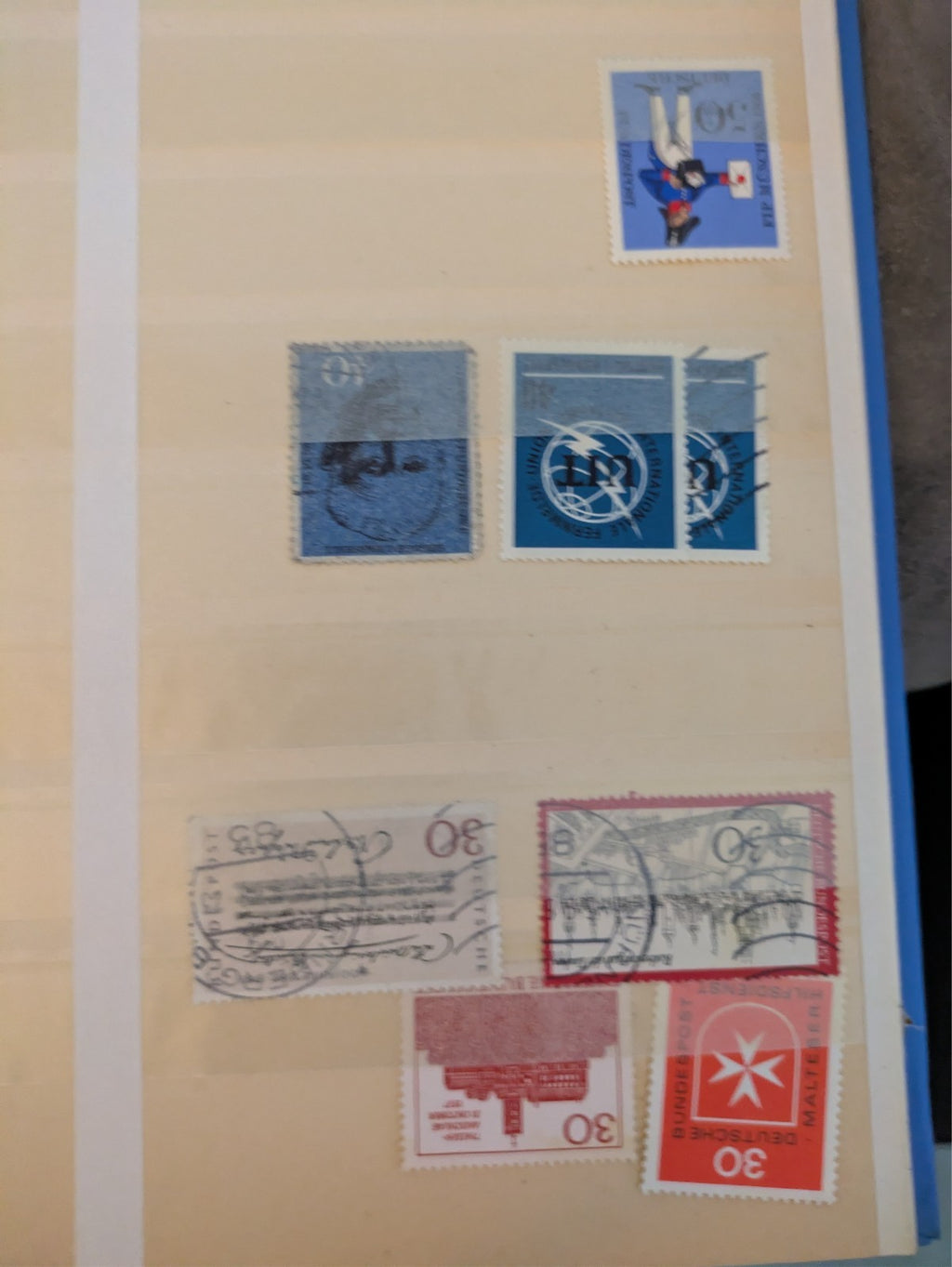 Beige postage stamp album featuring over 1000 stamps from Germany and Europe.