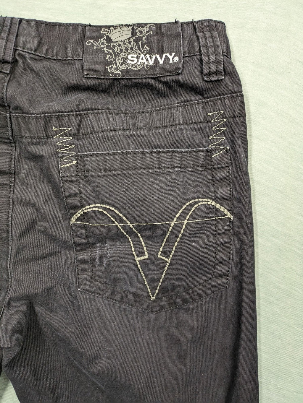 Savvy black pants straight fit with button fly, embroidered details and unique stitching.