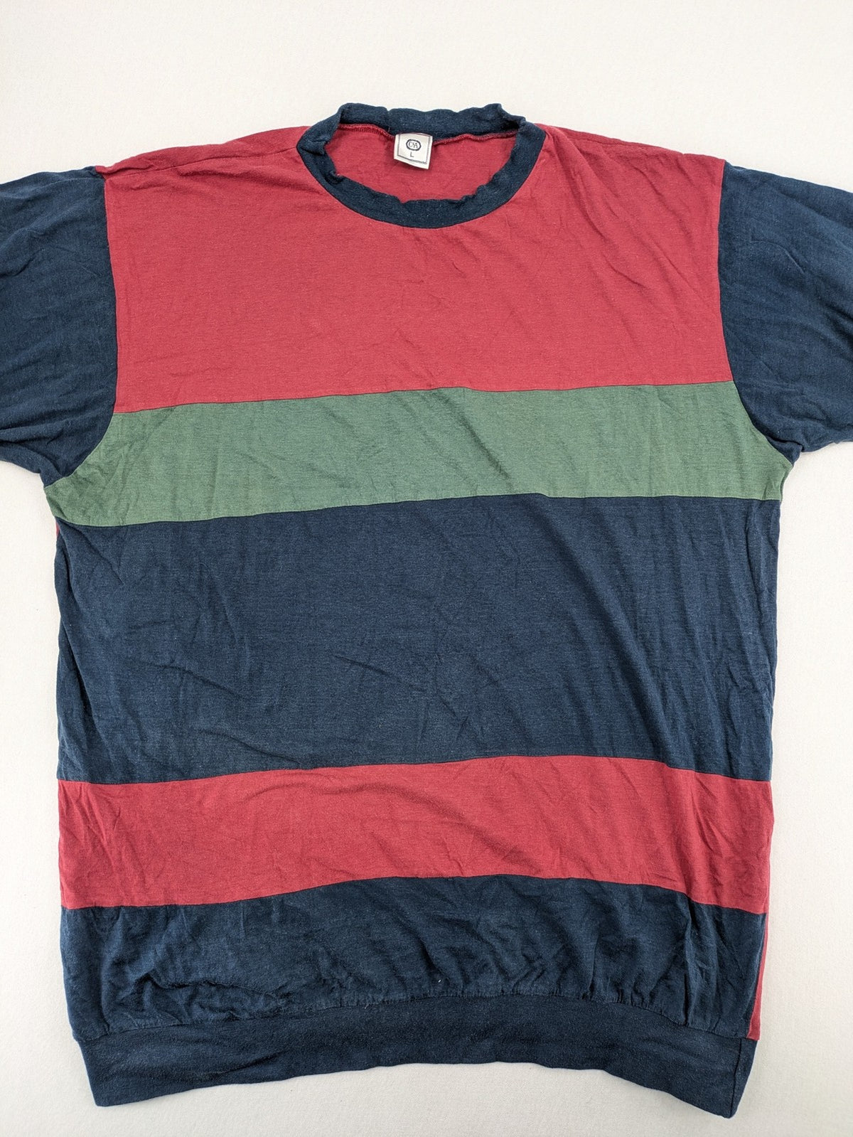 C&A green navy red colorblock long sleeve top with wide striped pattern and round neckline.
