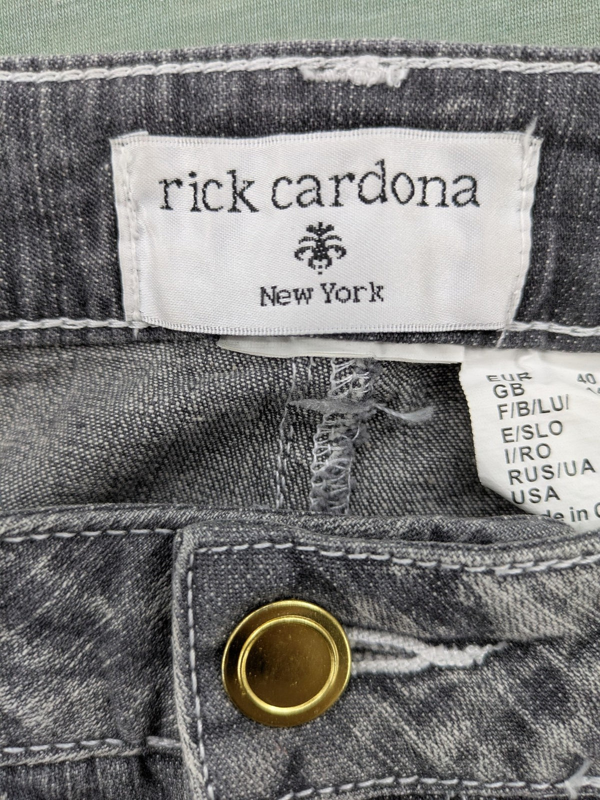 Rick Cardona grey cropped straight jeans with frayed hems and sparkling rhinestone details.