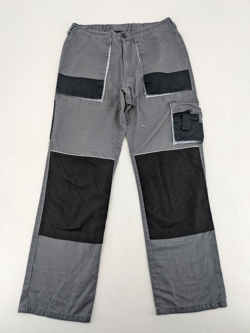 Watsons grey and black hunting tactical pants with Cordura reinforcements and elastic waistband.