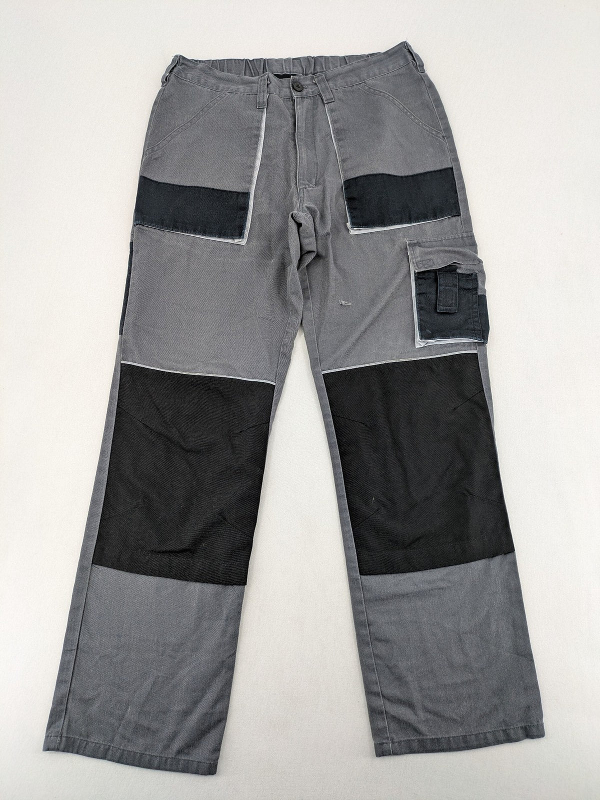Watsons grey and black hunting tactical pants with Cordura reinforcements and elastic waistband.