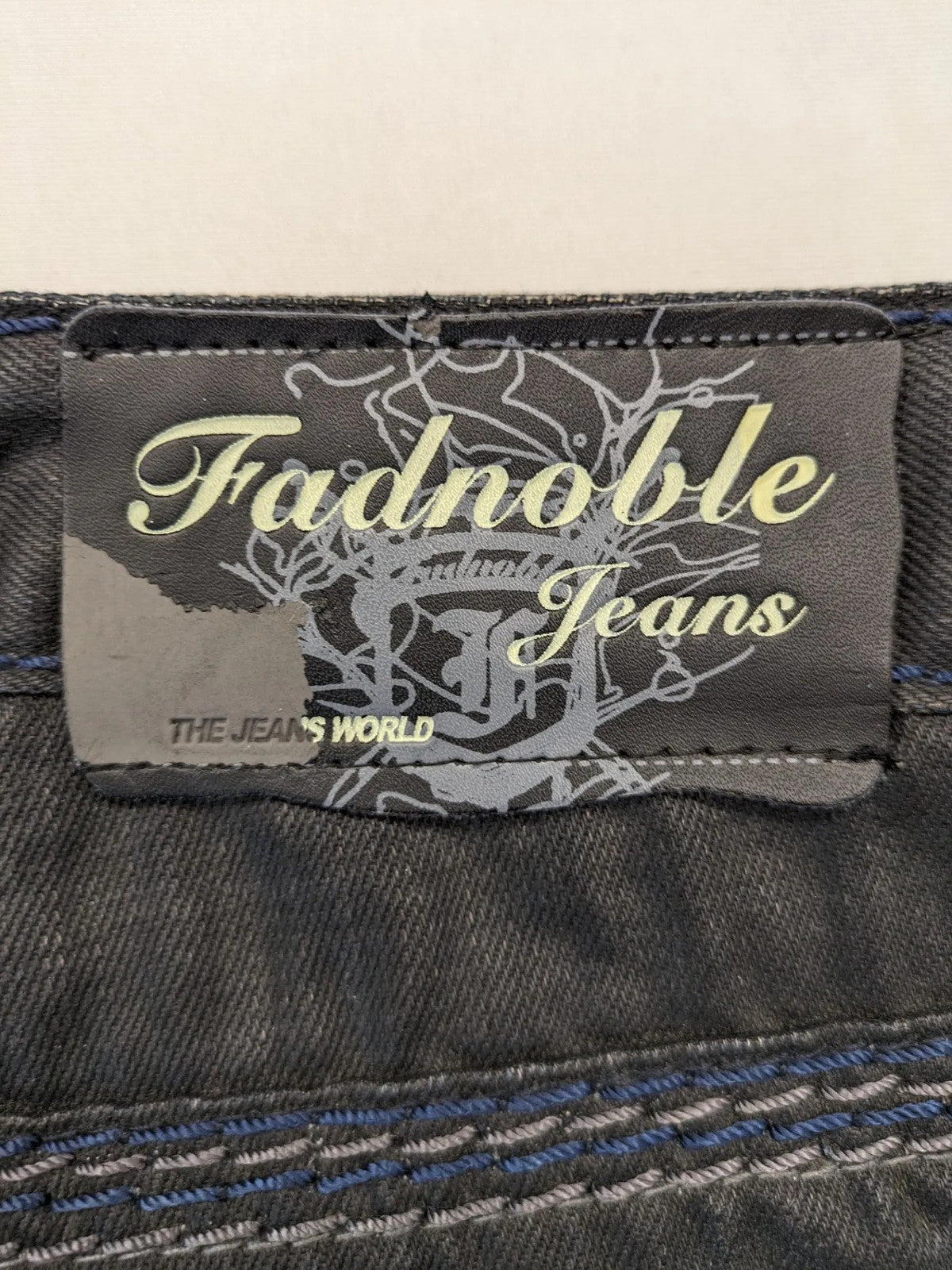 Fadnoble grey straight jeans with button fly and contrasting stitching details.