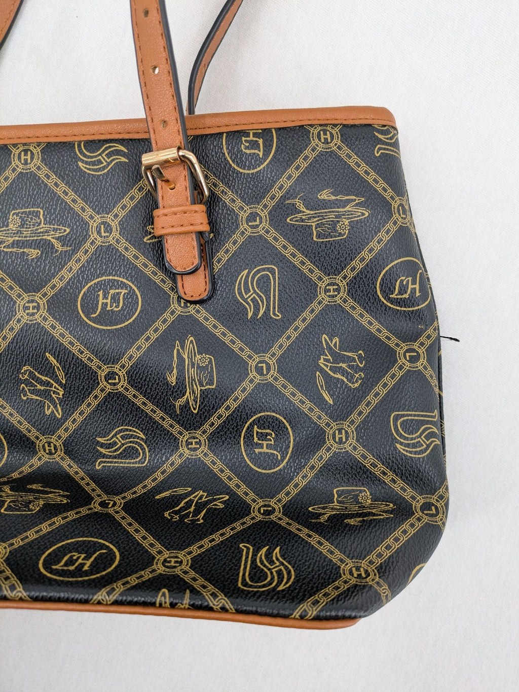 L&H brown and black handbag with monogram pattern and gold accents, versatile shoulder strap.