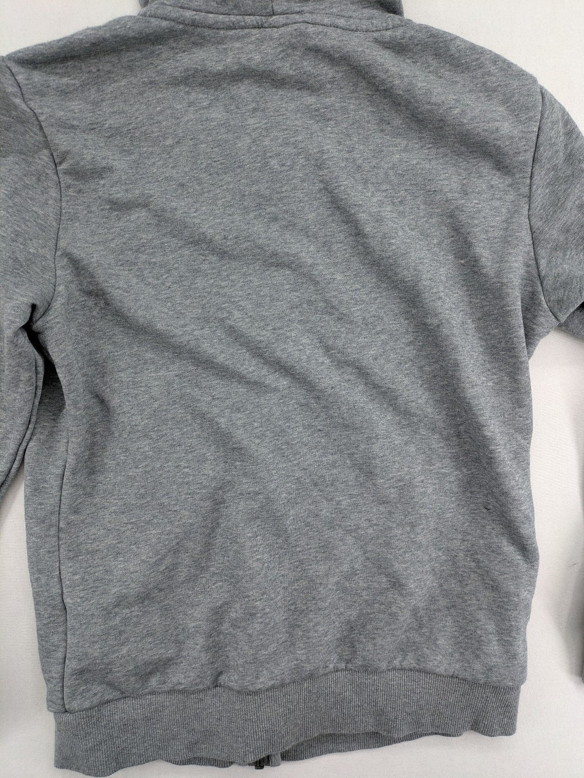 Puma grey full zip hoodie with adjustable drawstring hood and logo detail.