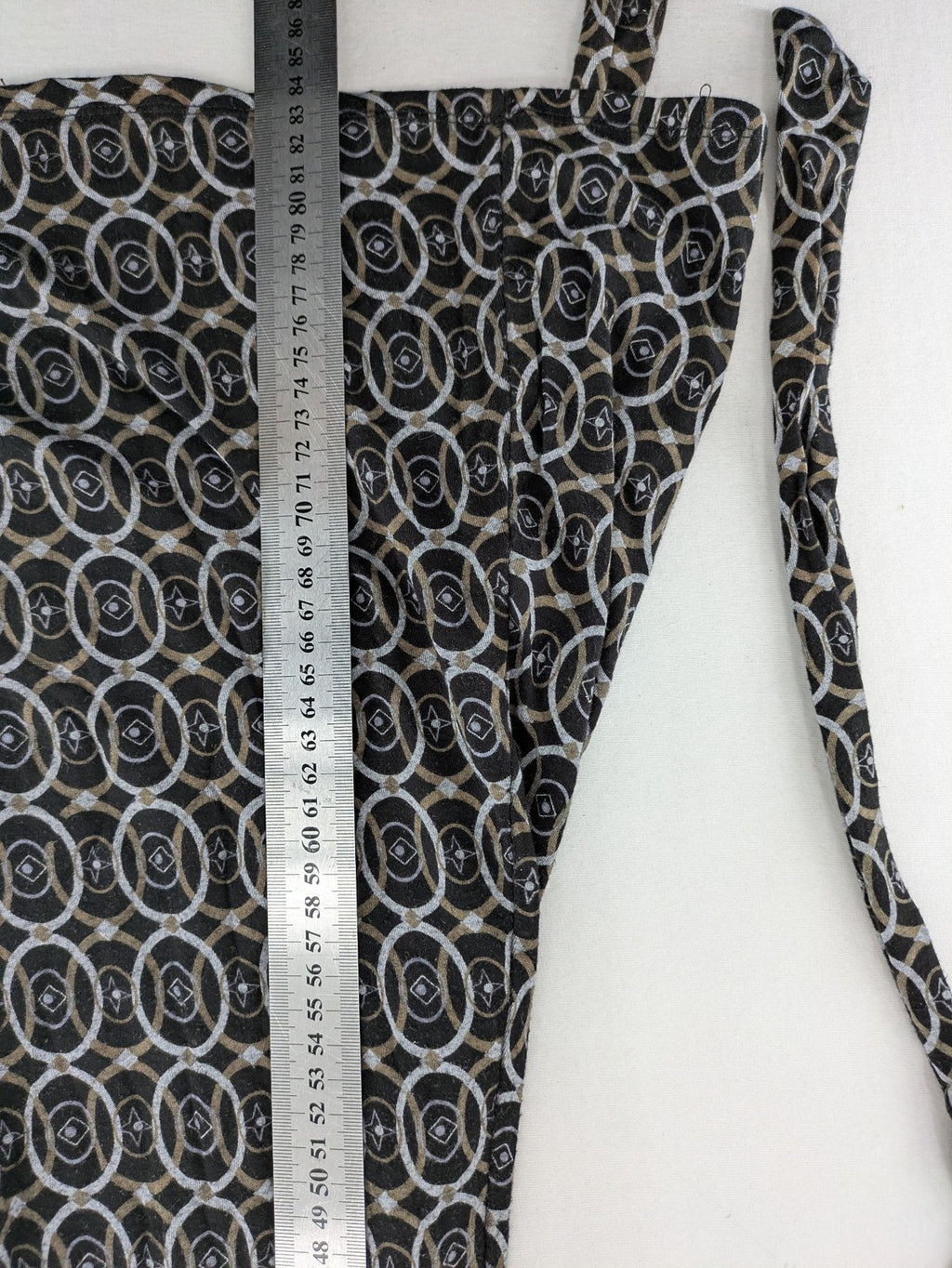 TCM pink wrap dress with V-neck, 3/4 sleeves, geometric black, white, and brown pattern.