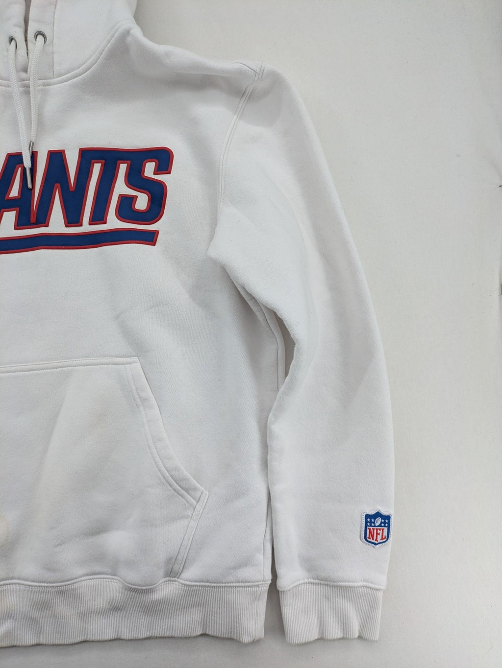 New York white hoodie with raised blue and red "GIANTS" logo and adjustable hood.