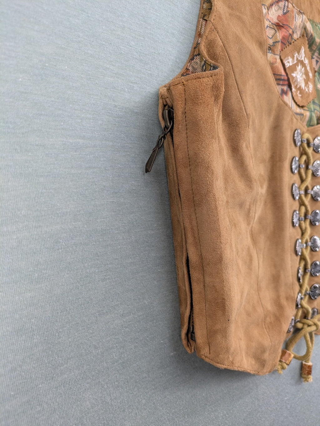 St. Moritz multi Trachtenweste brown genuine leather with decorative lacing and colorful satin lining.